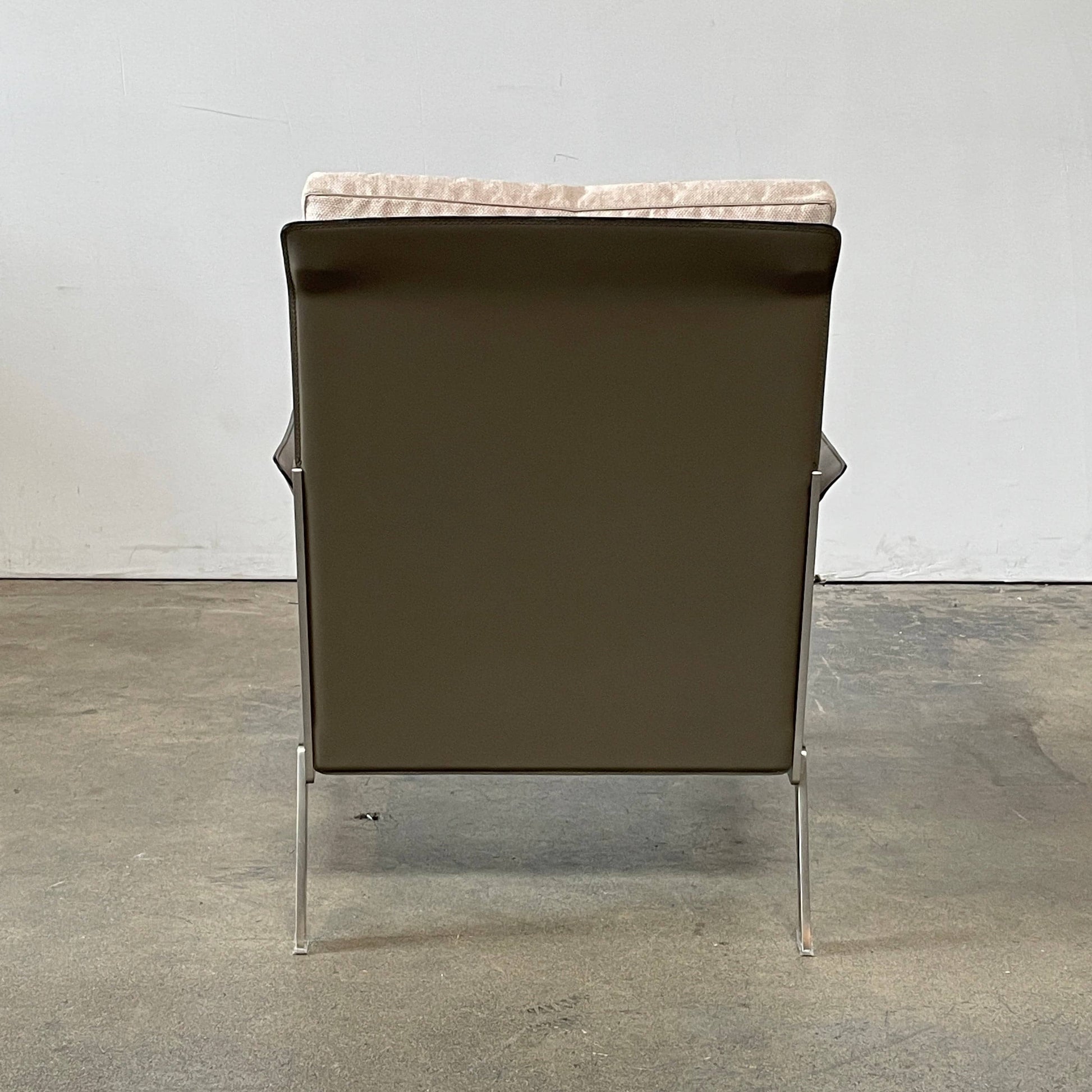 A Flexform Happy-Hour Lounge Chair with a gray cushioned seat, black metal frame, and angled legs is shown against a white background.