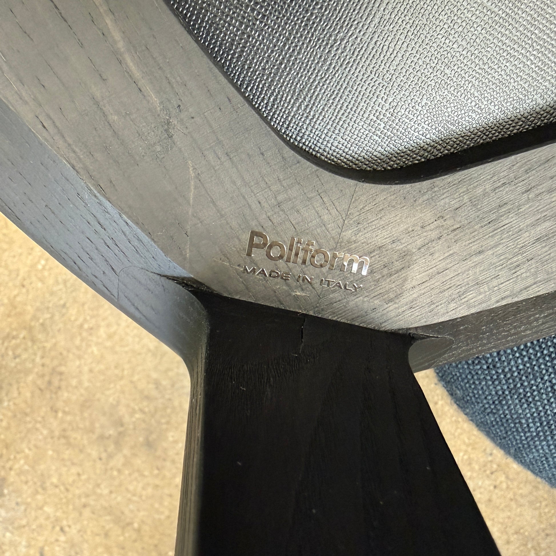 The Poliform Henry Marble Side Table, by Poliform, showcases an elegant small oval design with a luxurious Carrara marble top. It stands gracefully on four black Elm legs against a minimalist white backdrop.