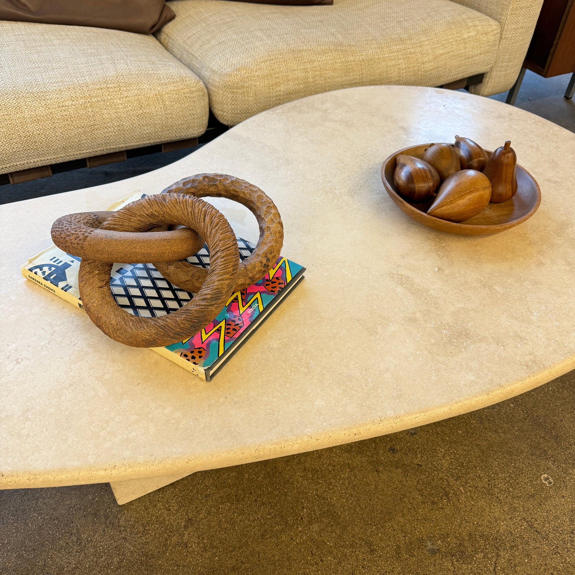 The Artist Sofi Ceramics Carved Rings feature two interlocking brown wooden rings with varied textures, evocative of ceramic artistry, shown on a plain white background.