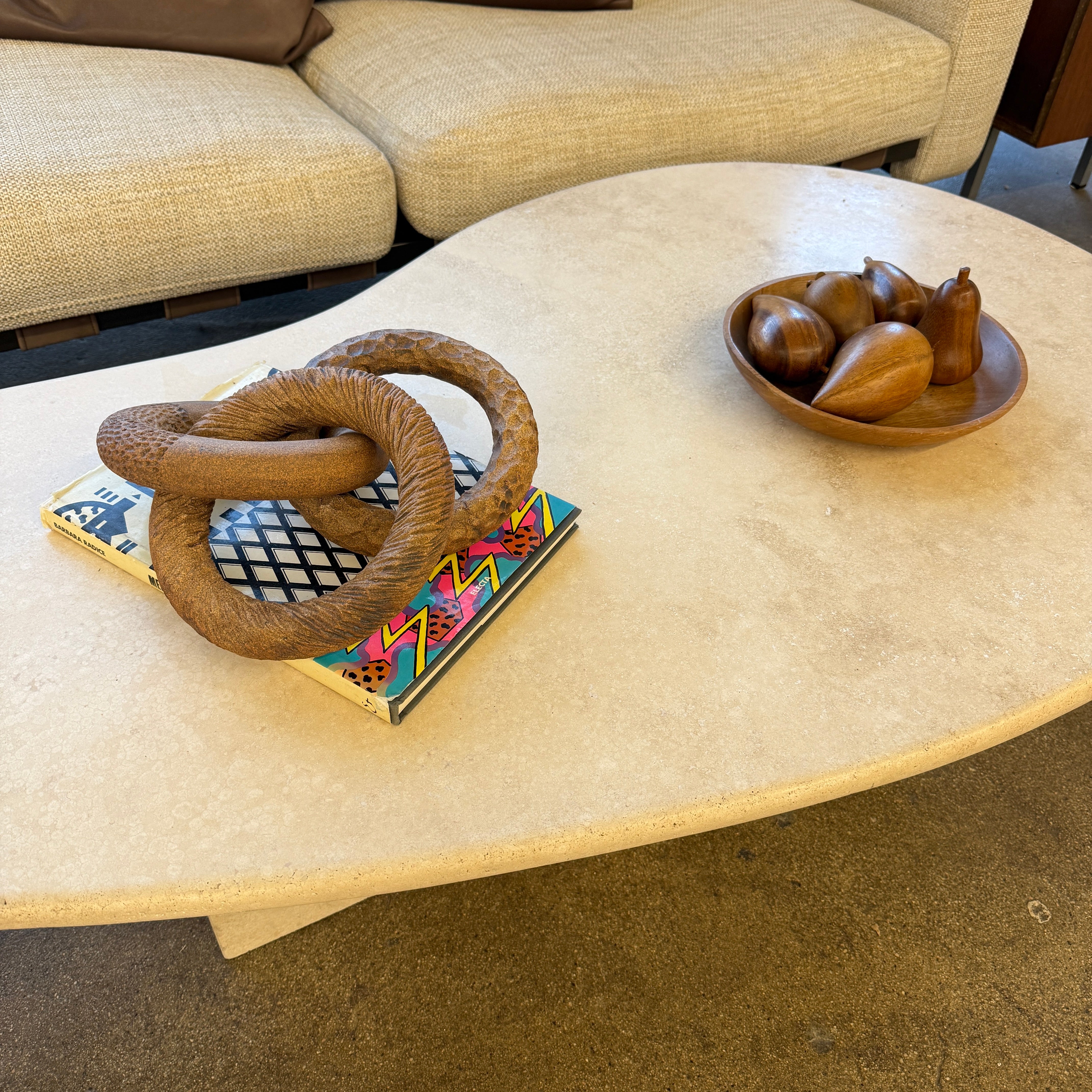 The Artist Sofi Ceramics Carved Rings feature two interlocking brown wooden rings with varied textures, evocative of ceramic artistry, shown on a plain white background.