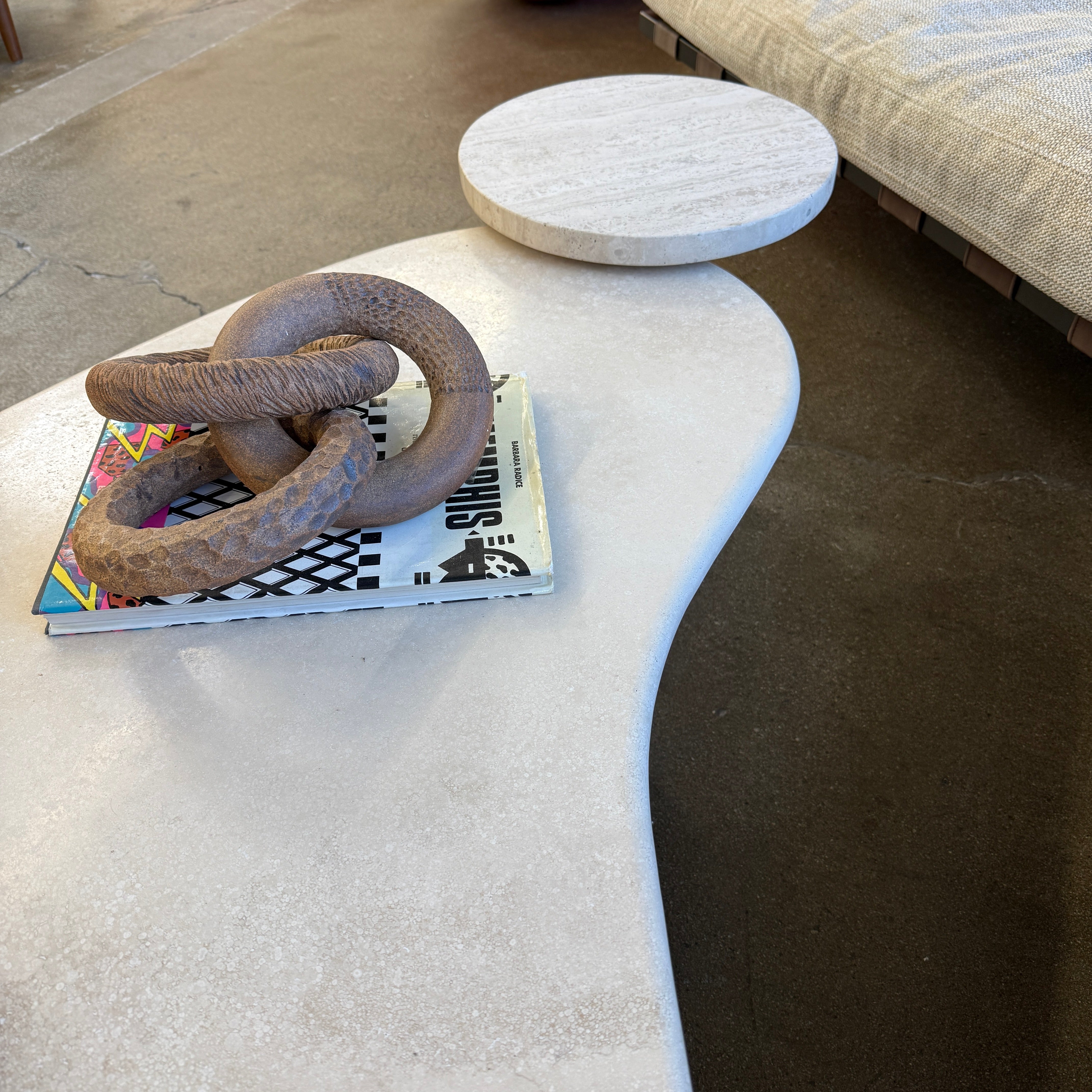 The Artist Sofi Ceramics Carved Rings feature two interlocking brown wooden rings with varied textures, evocative of ceramic artistry, shown on a plain white background.