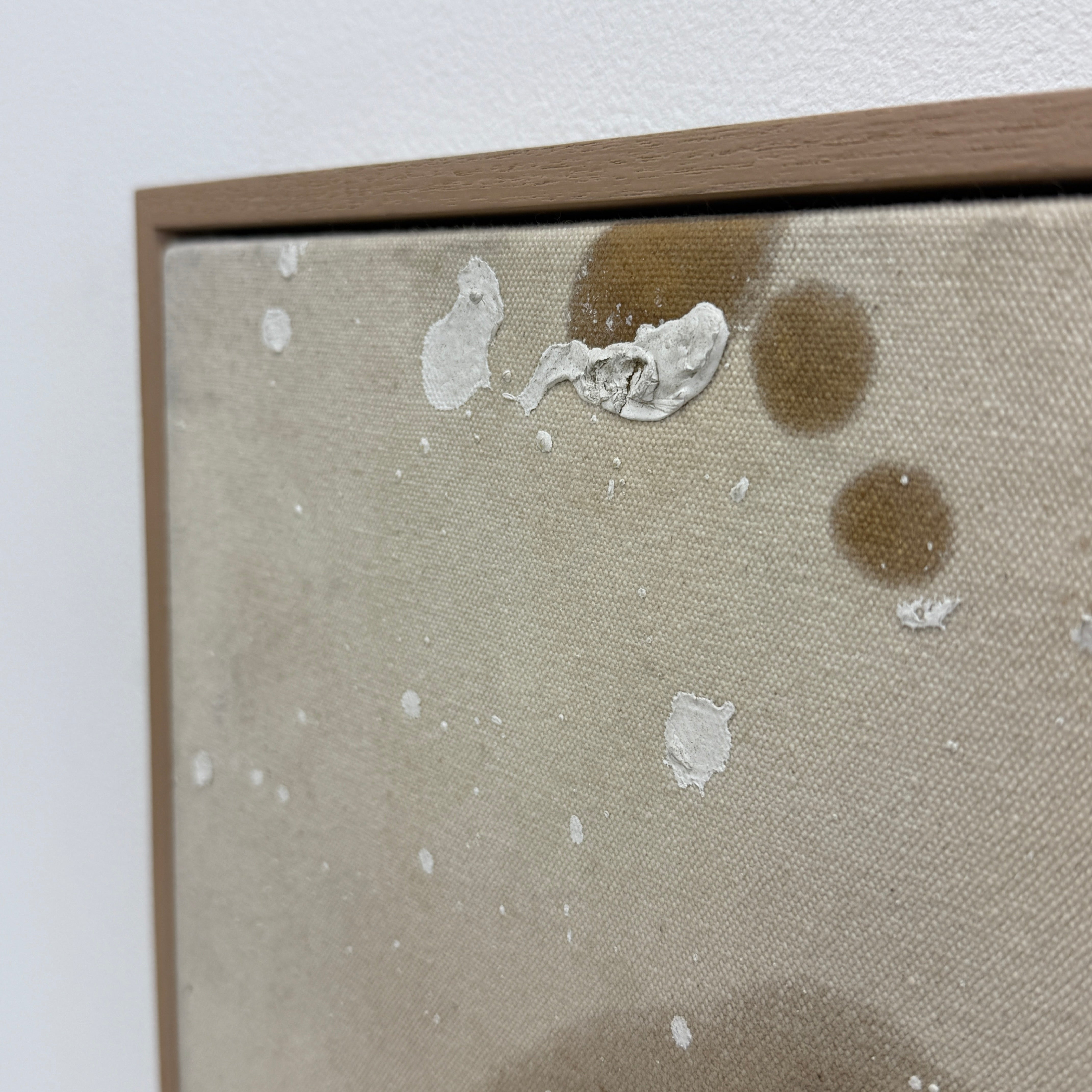 Framed Painting: Allison Caesar Mixed Media #2 - Untitled by Artist features abstract forms in brown and yellow-green with white splatters on a beige background, showcased in a thin frame.