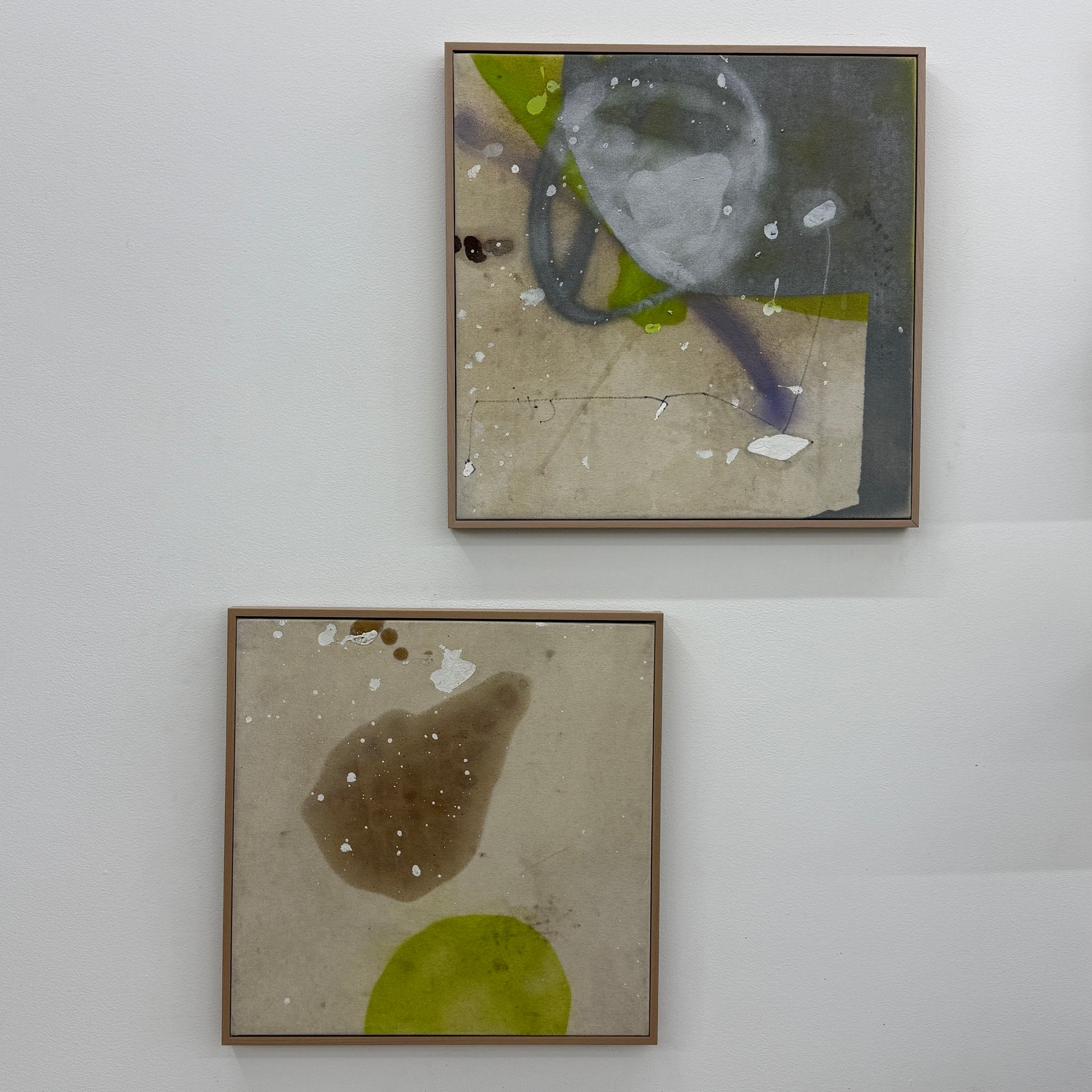 Framed Painting: Allison Caesar Mixed Media #2 - Untitled by Artist features abstract forms in brown and yellow-green with white splatters on a beige background, showcased in a thin frame.