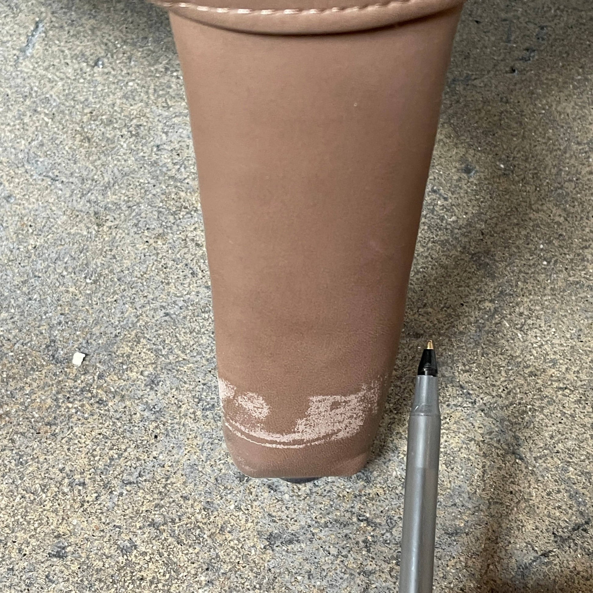 A brown leather armchair with a high backrest and curved arms, showcasing classic leather upholstery, is paired with a matching ottoman, both resting on thin legs. This sophisticated set embodies the elegant style of Maxalto's Maxalto Febo High Back Lounge Chair and Ottoman collection.