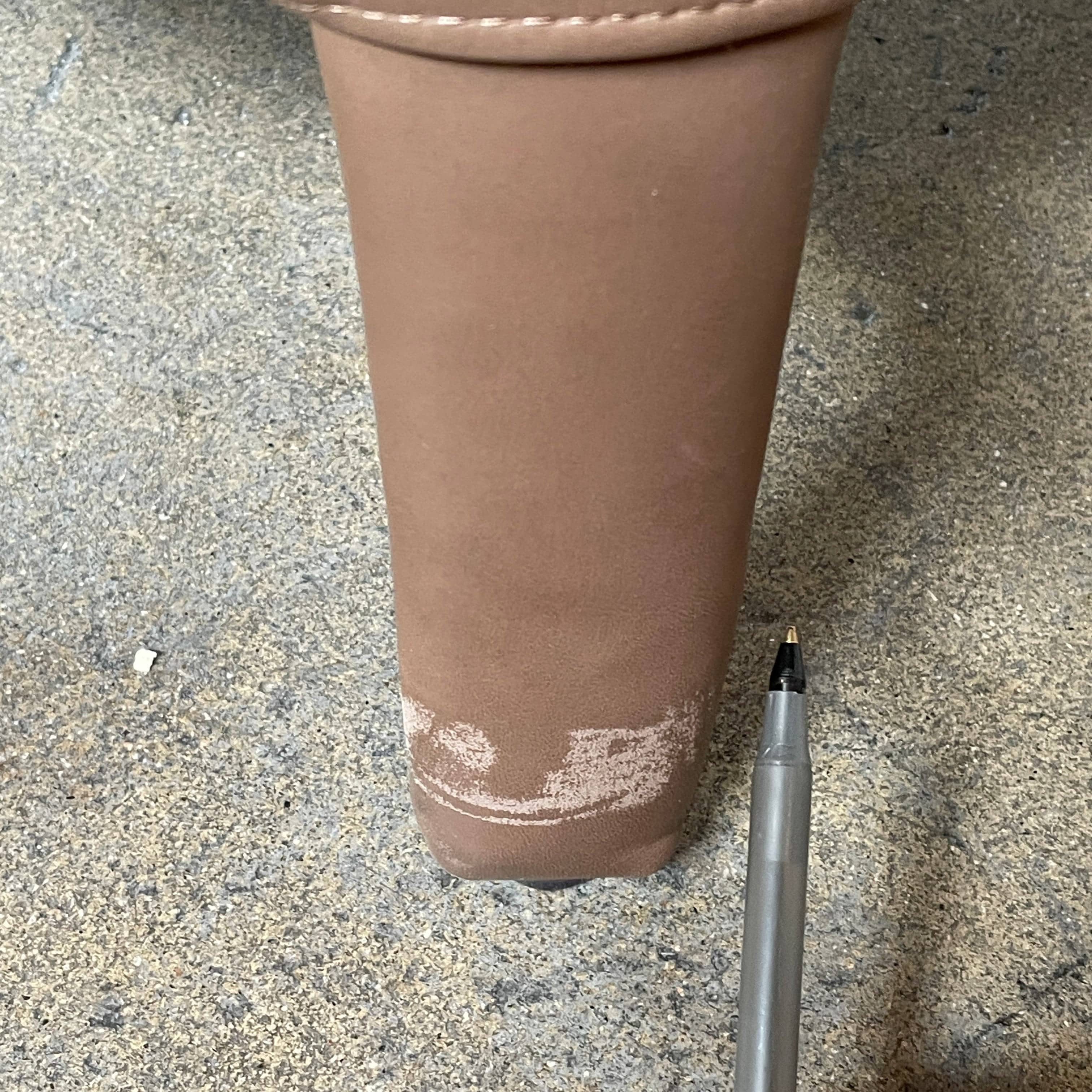 A brown leather armchair with a high backrest and curved arms, showcasing classic leather upholstery, is paired with a matching ottoman, both resting on thin legs. This sophisticated set embodies the elegant style of Maxalto's Maxalto Febo High Back Lounge Chair and Ottoman collection.