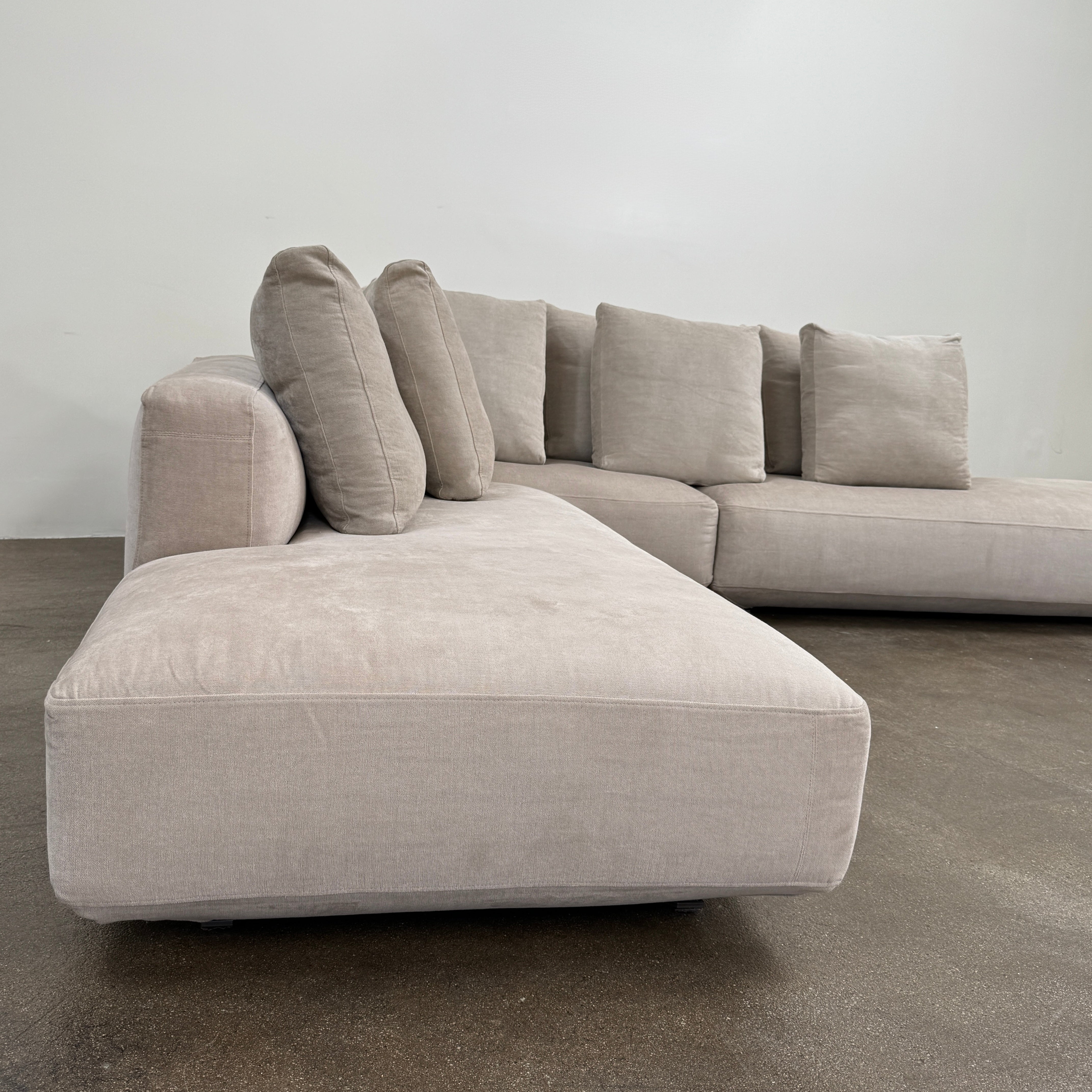 The Zanotta Pianoalto 3 Piece Sectional by Zanotta features light gray brushed cotton blend upholstery and five matching back cushions for ergonomic support, shown against a plain white background.