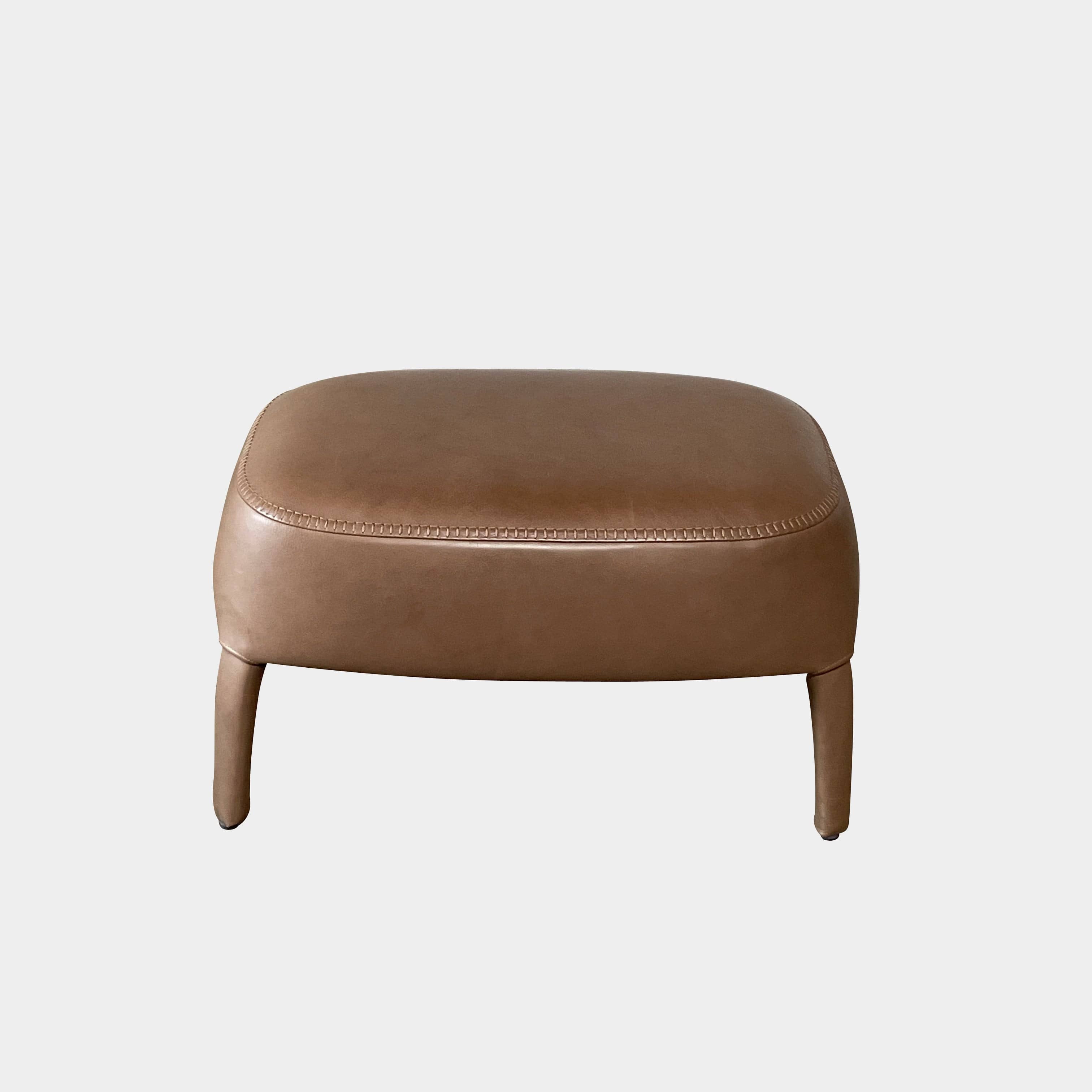 A brown leather armchair with a high backrest and curved arms, showcasing classic leather upholstery, is paired with a matching ottoman, both resting on thin legs. This sophisticated set embodies the elegant style of Maxalto's Maxalto Febo High Back Lounge Chair and Ottoman collection.