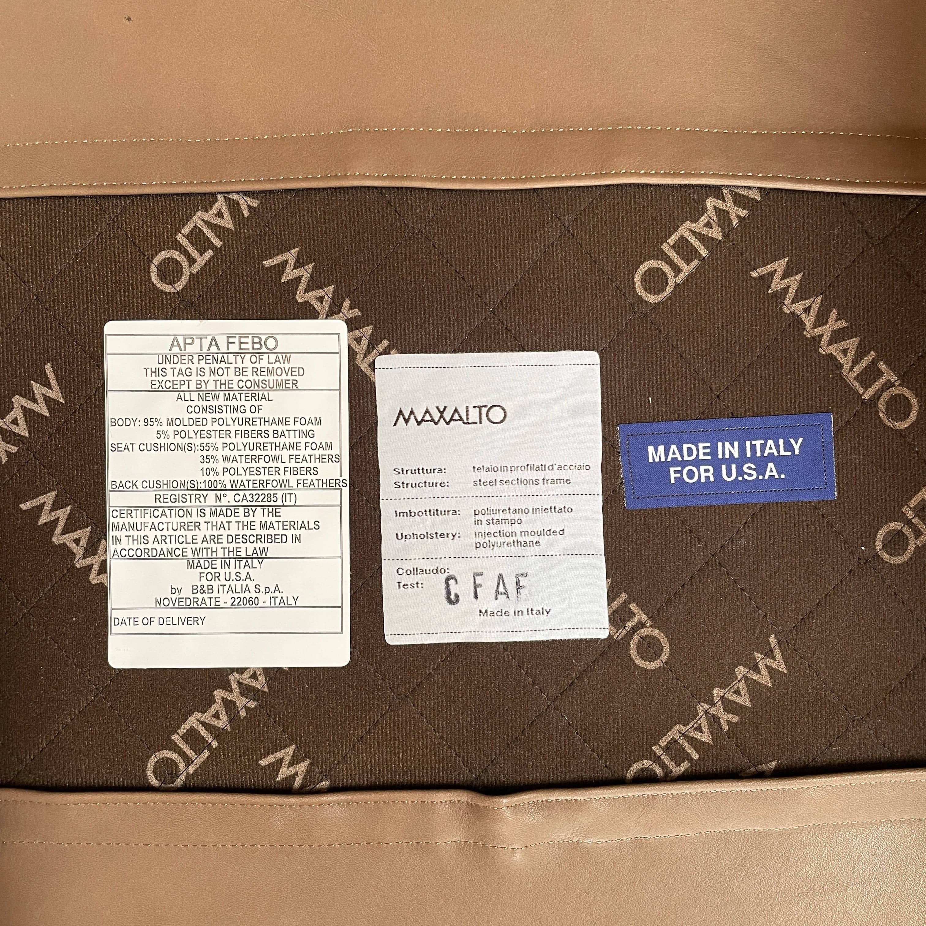 A brown leather armchair with a high backrest and curved arms, showcasing classic leather upholstery, is paired with a matching ottoman, both resting on thin legs. This sophisticated set embodies the elegant style of Maxalto's Maxalto Febo High Back Lounge Chair and Ottoman collection.