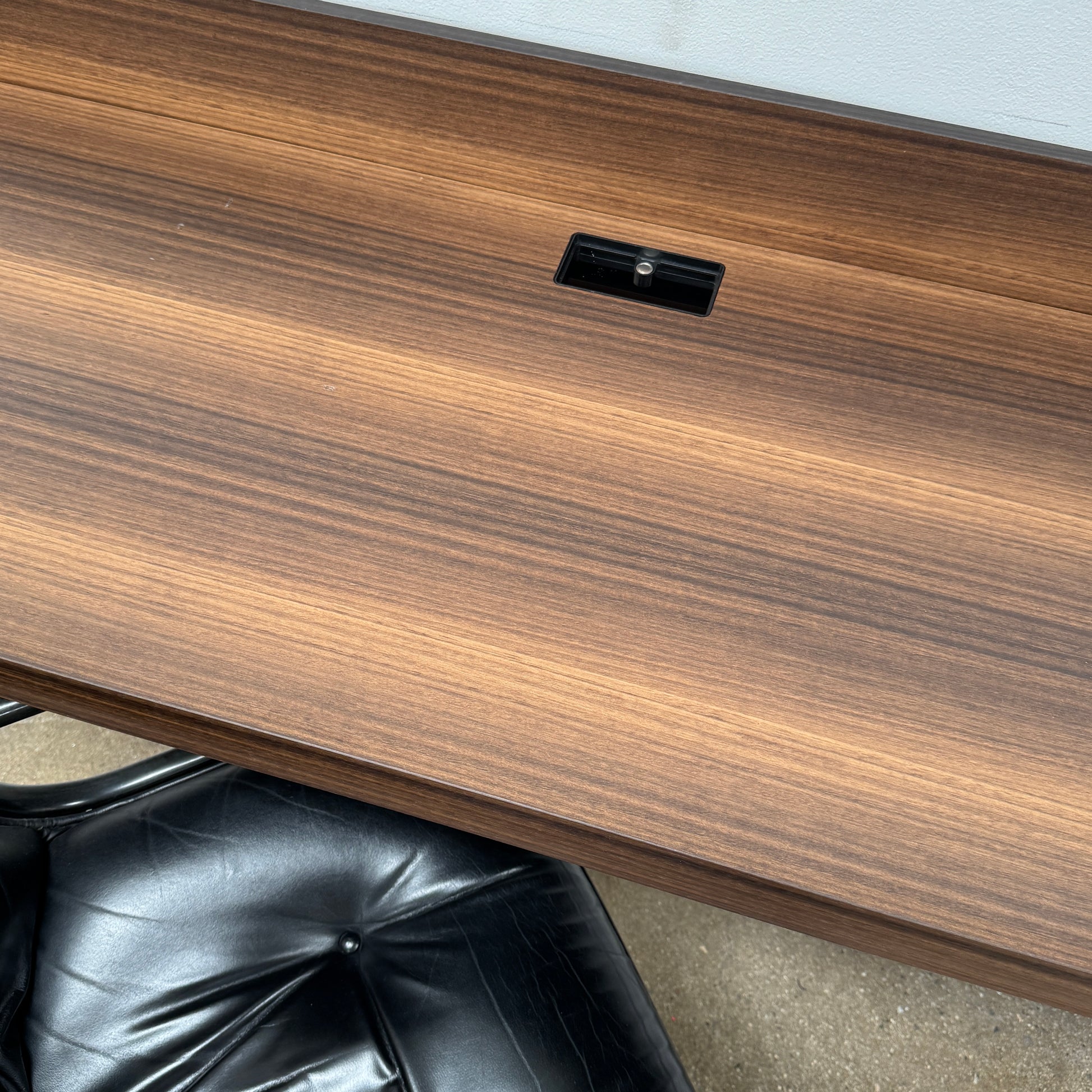 The Molteni & C Fortepiano Wall-mounted Desk System features a long wooden shelf, beige storage cabinets, and drawers for a sleek, modern look against a white wall.