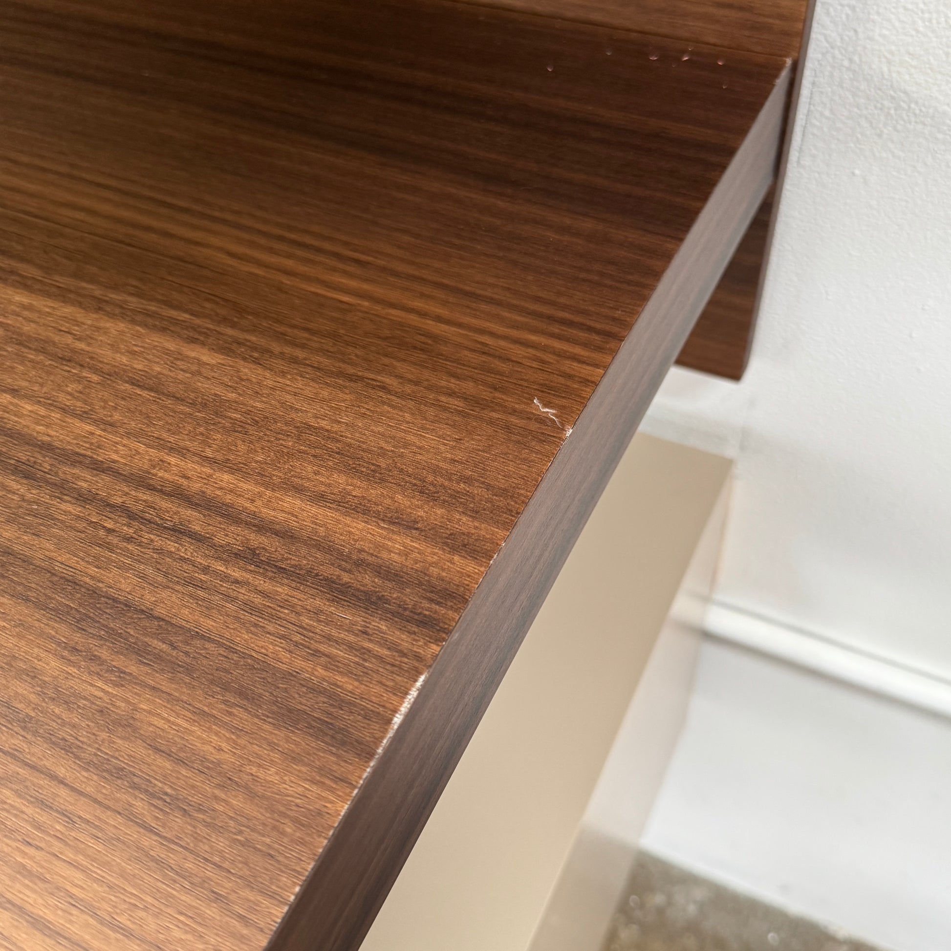 The Molteni & C Fortepiano Wall-mounted Desk System features a long wooden shelf, beige storage cabinets, and drawers for a sleek, modern look against a white wall.