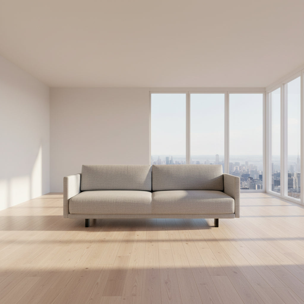 The DWR Tuck Sleeper Sofa by DWR features modern light gray fabric, straight arms, and black legs—ideal for a guest room. Shown against a plain white background.
