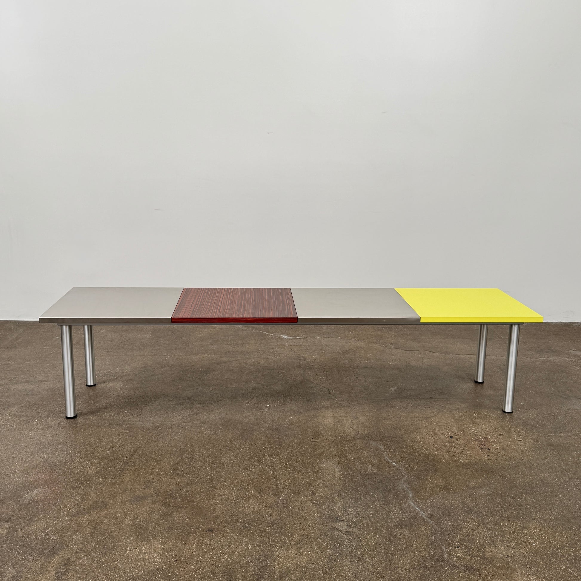 A Mazzei Multi-Panel Table with a contemporary design featuring yellow, orange, and blue stripes.
