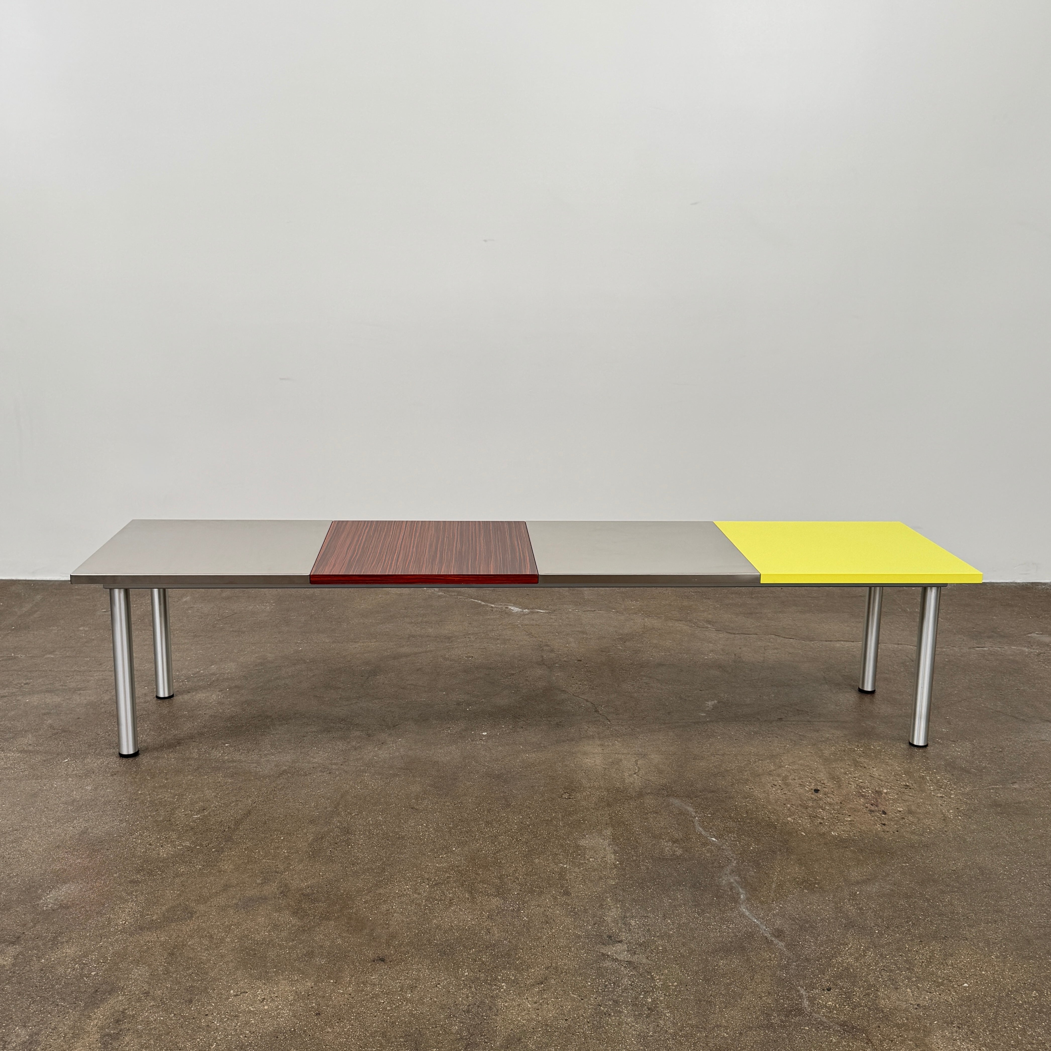 A Mazzei Multi-Panel Table with a contemporary design featuring yellow, orange, and blue stripes.