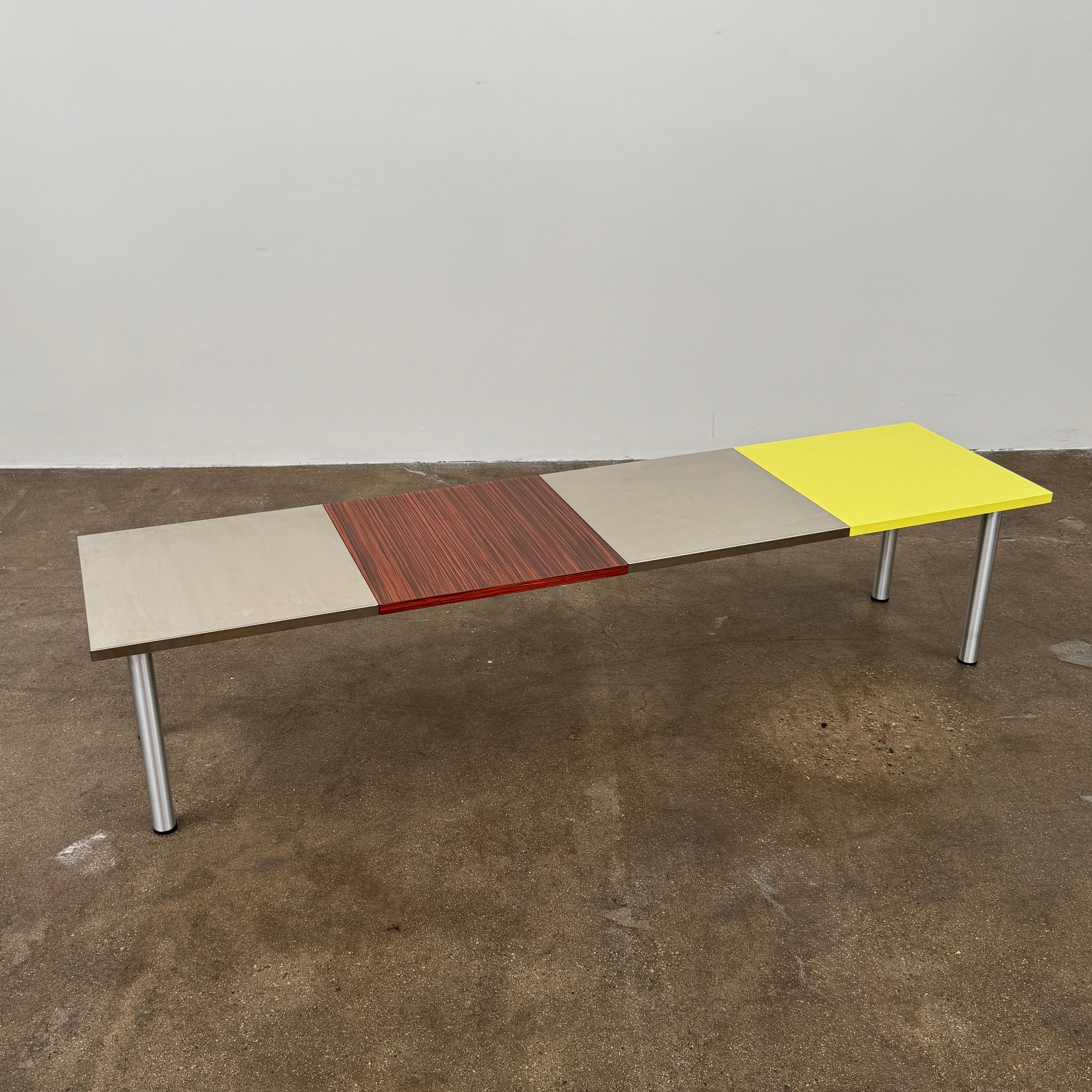 A Mazzei Multi-Panel Table with a contemporary design featuring yellow, orange, and blue stripes.