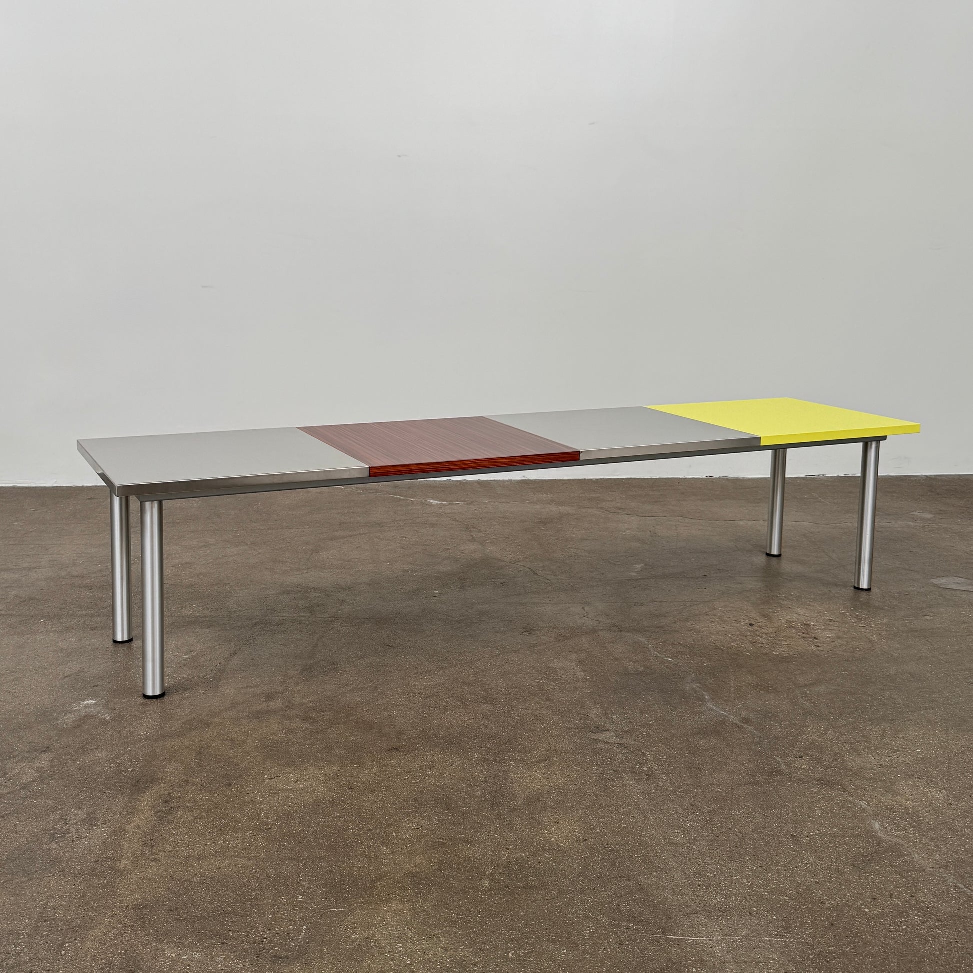 A Mazzei Multi-Panel Table with a contemporary design featuring yellow, orange, and blue stripes.