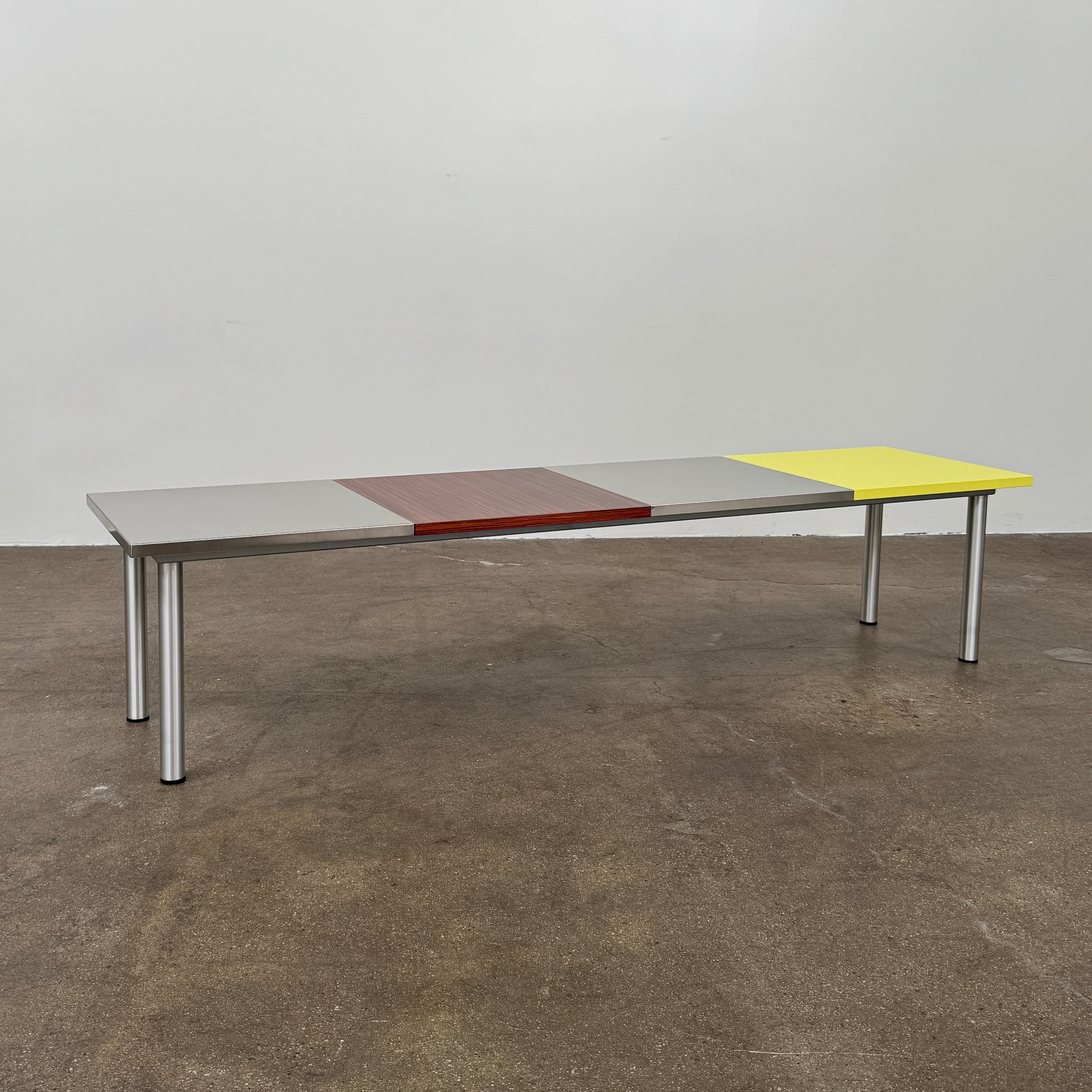 A Mazzei Multi-Panel Table with a contemporary design featuring yellow, orange, and blue stripes.