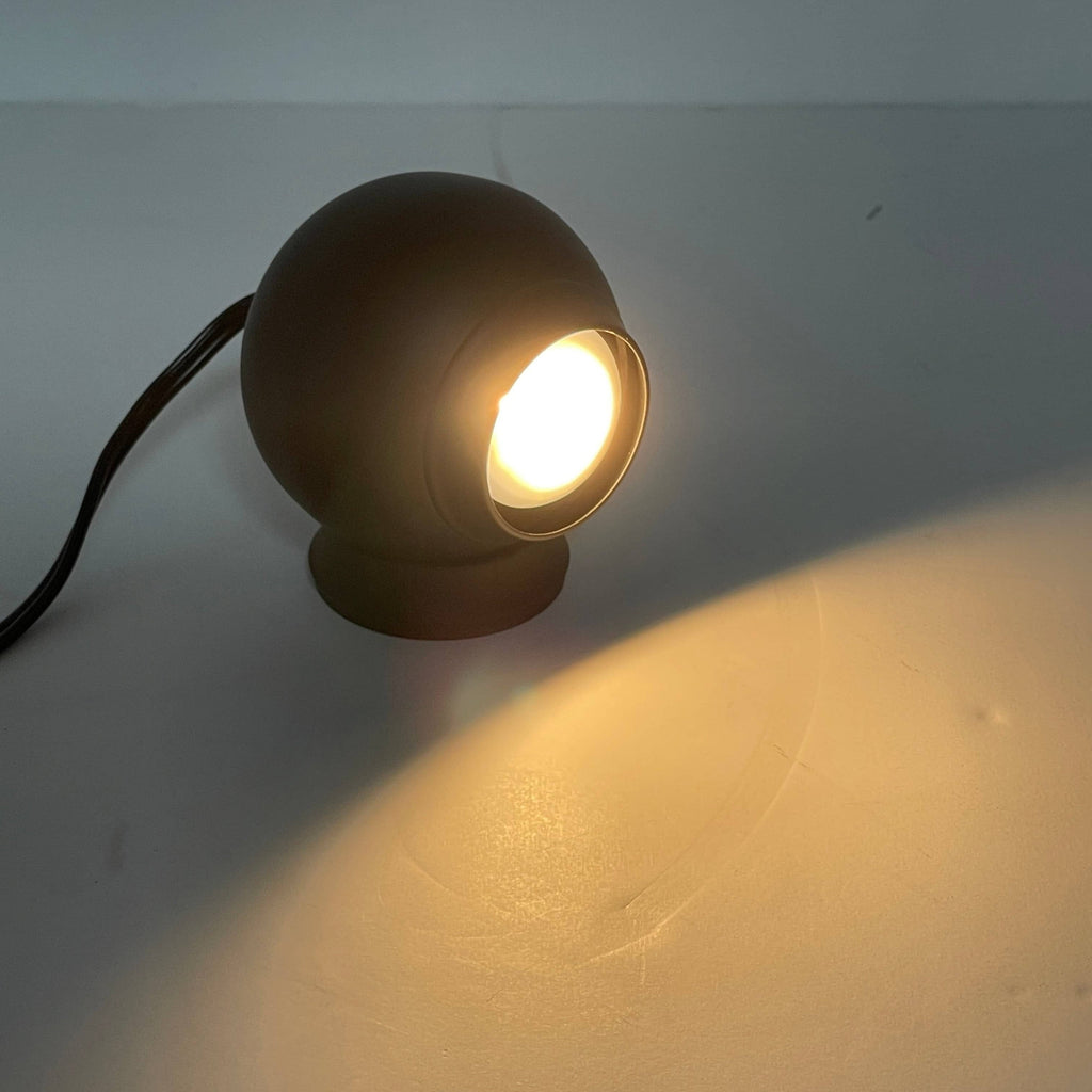 A gray Pip-Squeak Table Light on top of a white background.