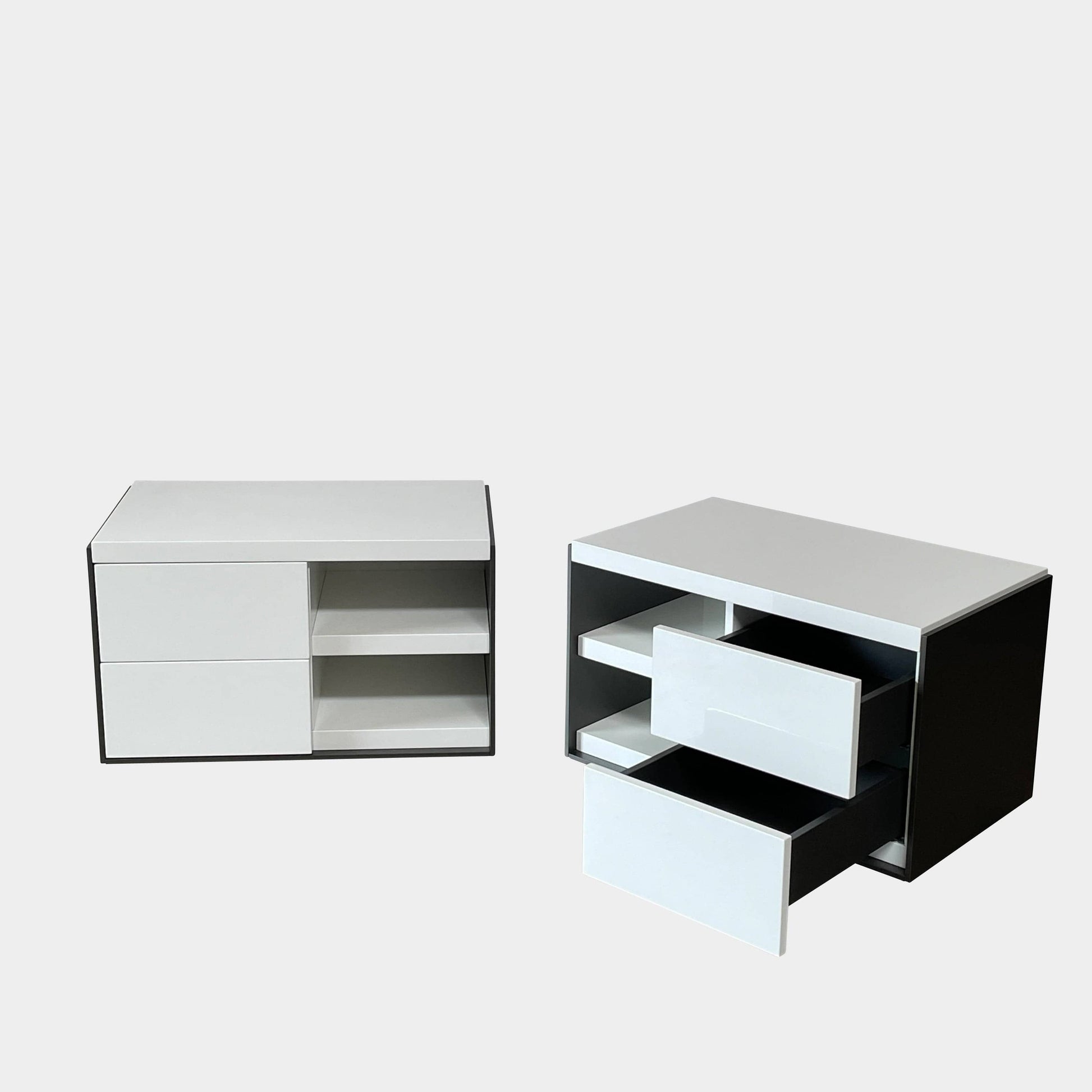 Two identical B&B Italia Surface Nightstands by B&B Italia, in a chic white finish with black trim, each featuring two drawers and open shelving in the middle. These modern pieces are perfect for any contemporary bedroom furniture arrangement.