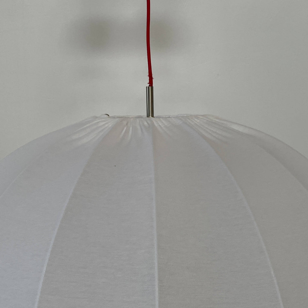 A Penta Balloon Light hanging lamp on a white wall.