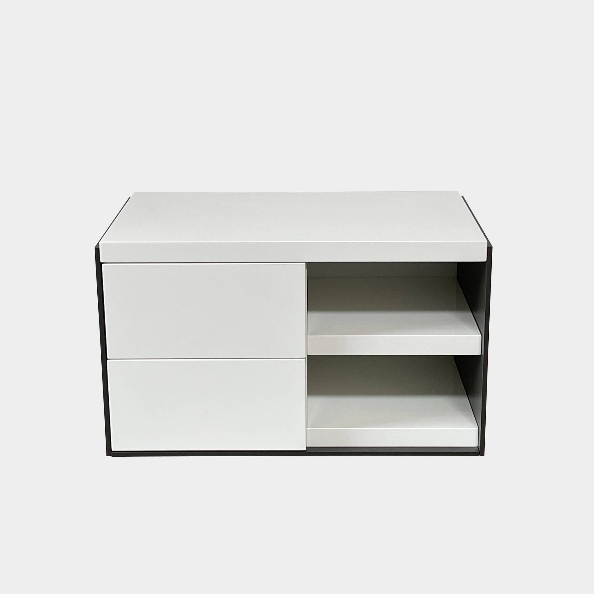 Two identical B&B Italia Surface Nightstands by B&B Italia, in a chic white finish with black trim, each featuring two drawers and open shelving in the middle. These modern pieces are perfect for any contemporary bedroom furniture arrangement.