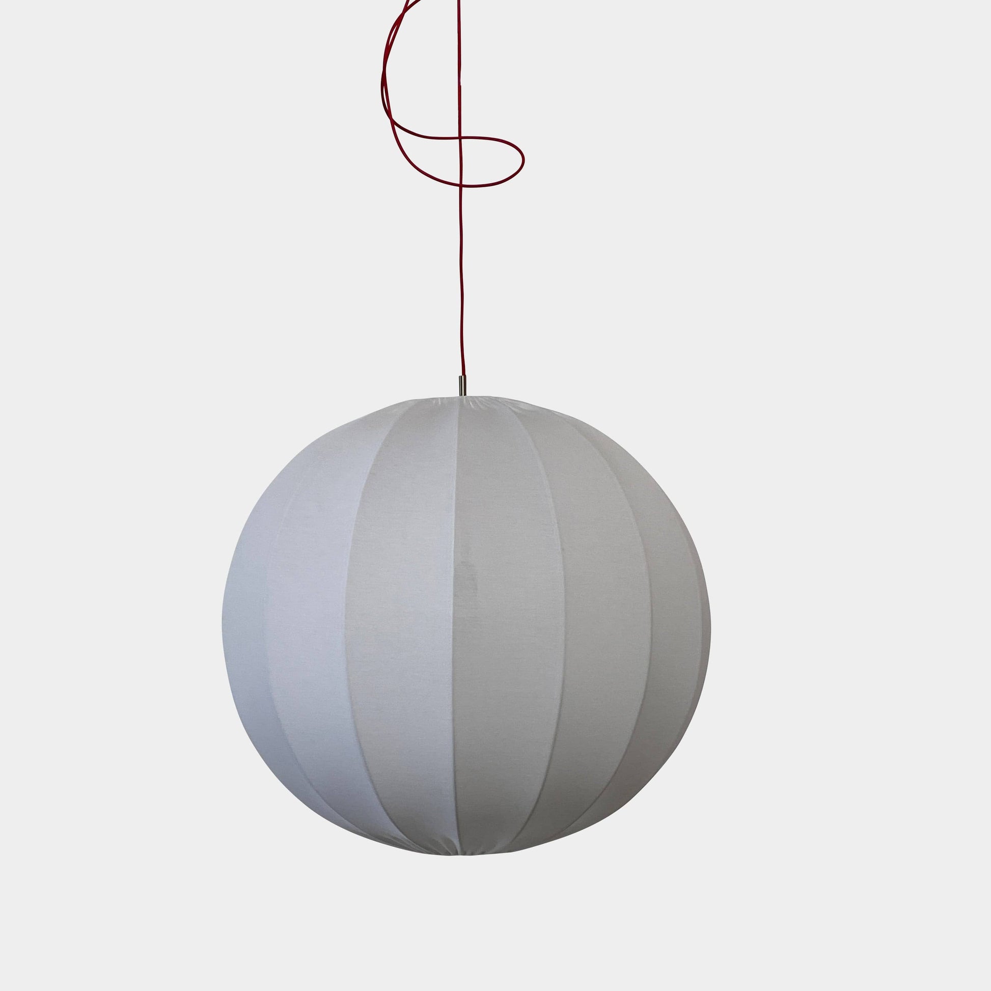 A Penta Balloon Light hanging lamp on a white wall.