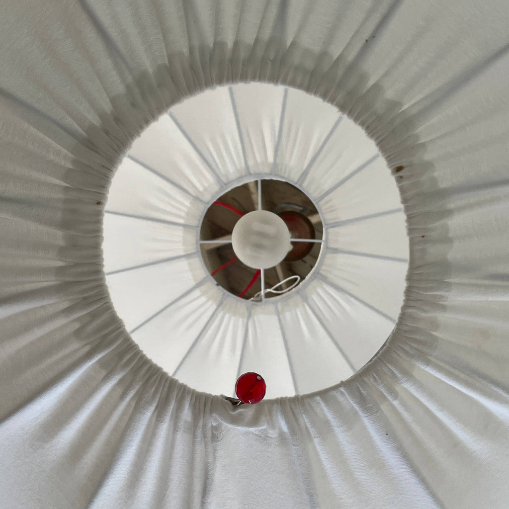 A Penta Balloon Light hanging lamp on a white wall.