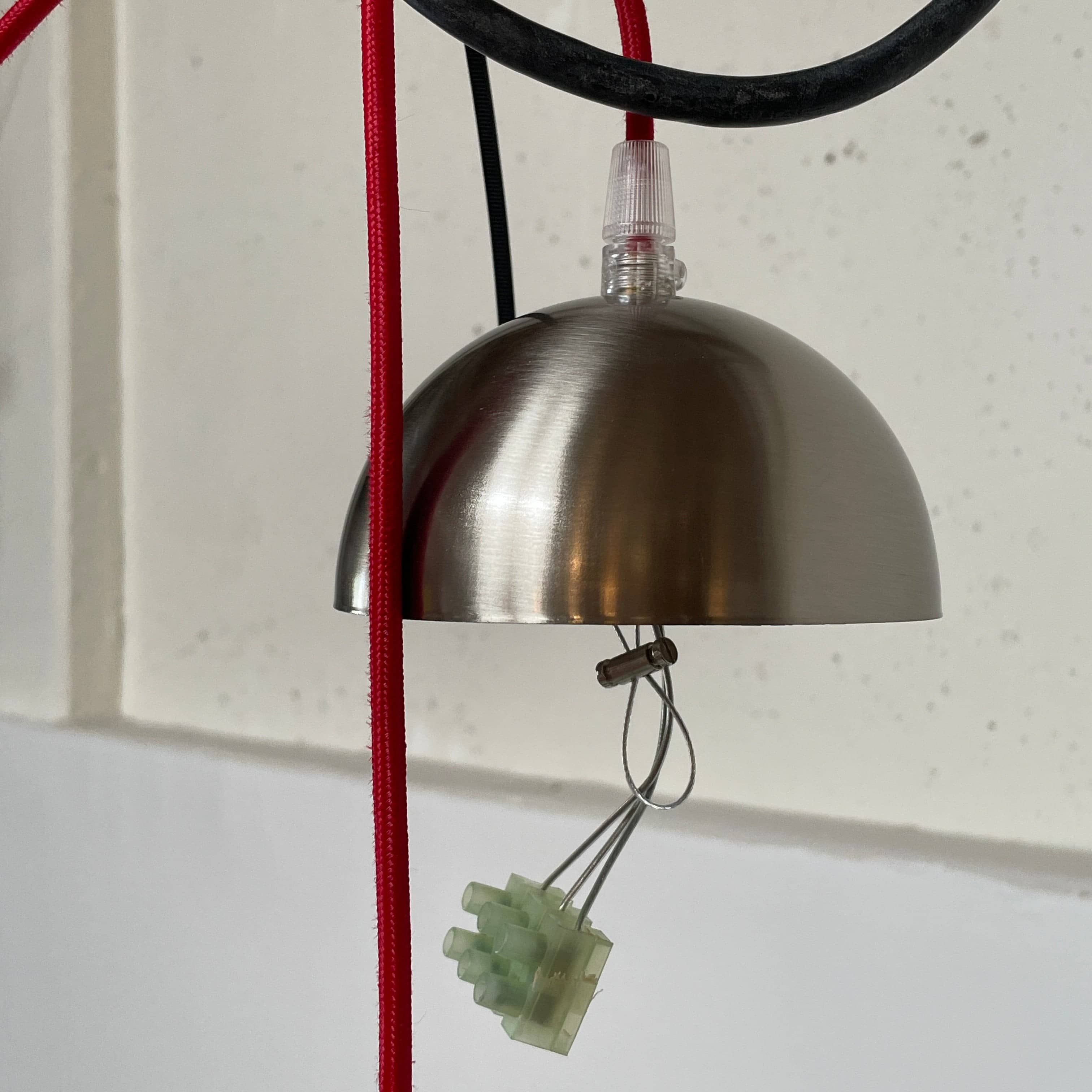 A Penta Balloon Light hanging lamp on a white wall.