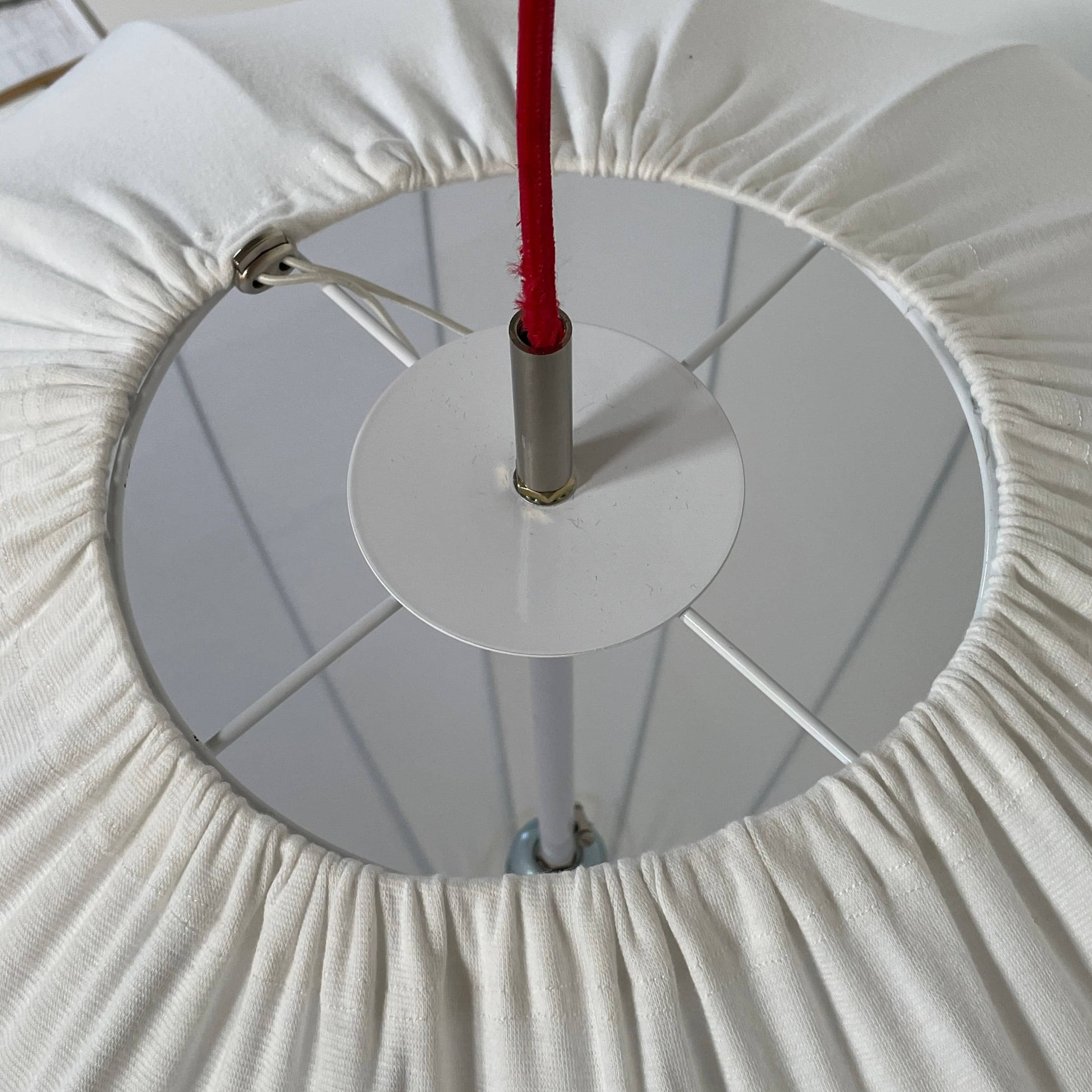 A Penta Balloon Light hanging lamp on a white wall.