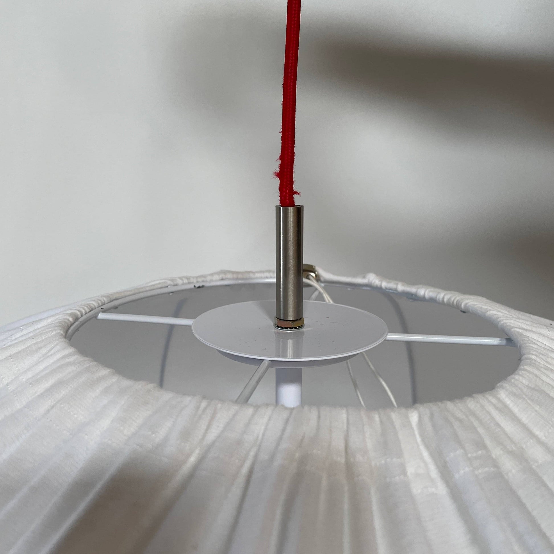 A Penta Balloon Light hanging lamp on a white wall.