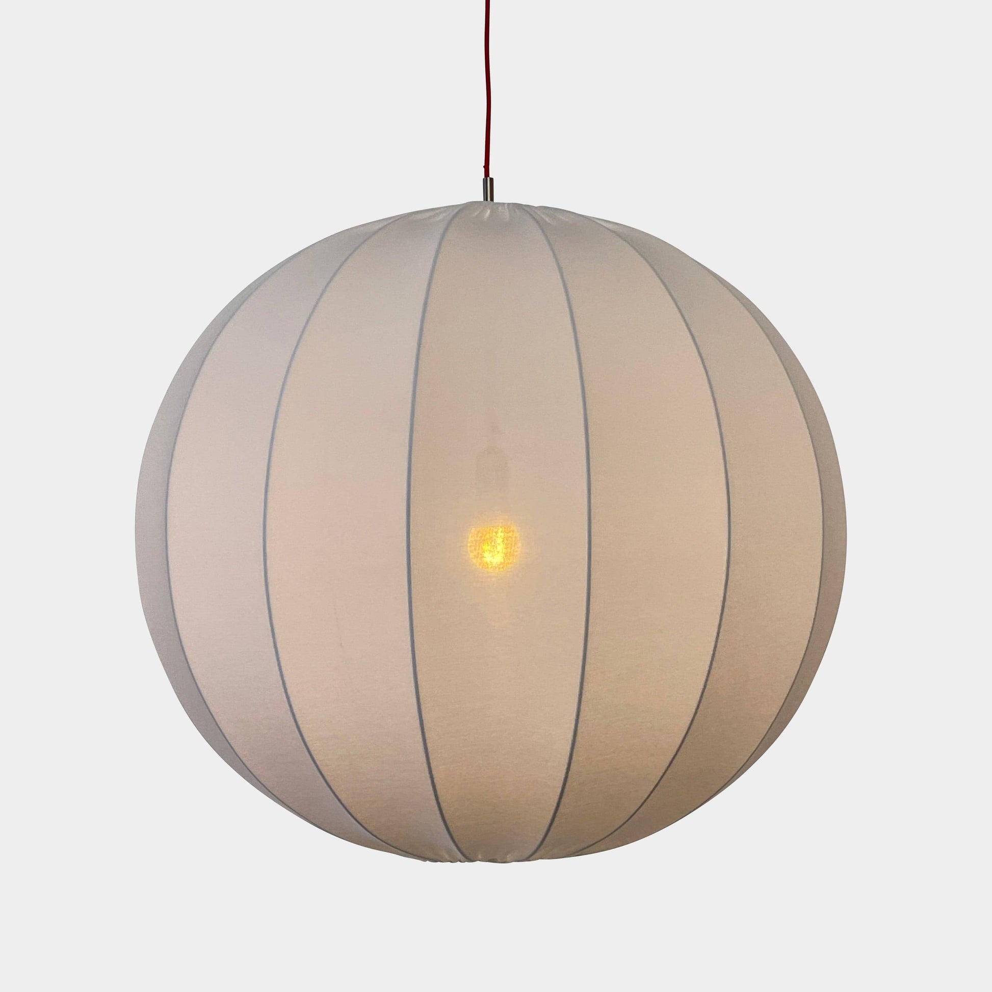 A Penta Balloon Light hanging lamp on a white wall.