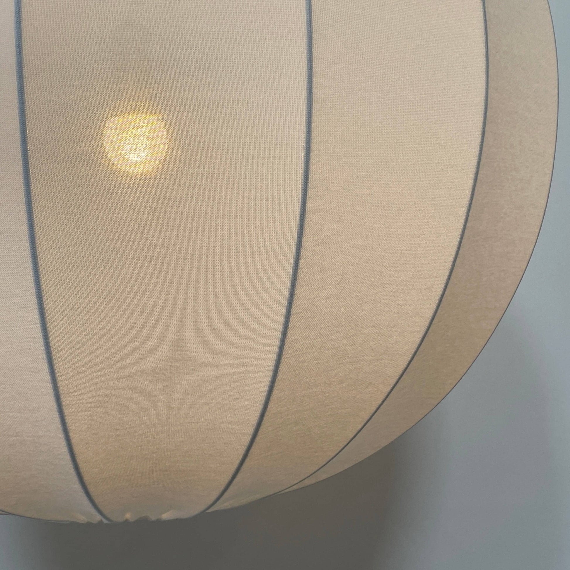 A Penta Balloon Light hanging lamp on a white wall.