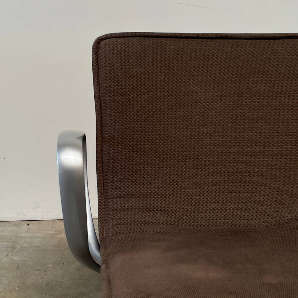 A Ligne Roset Smala Chair with metal legs and a brown upholstered seat.