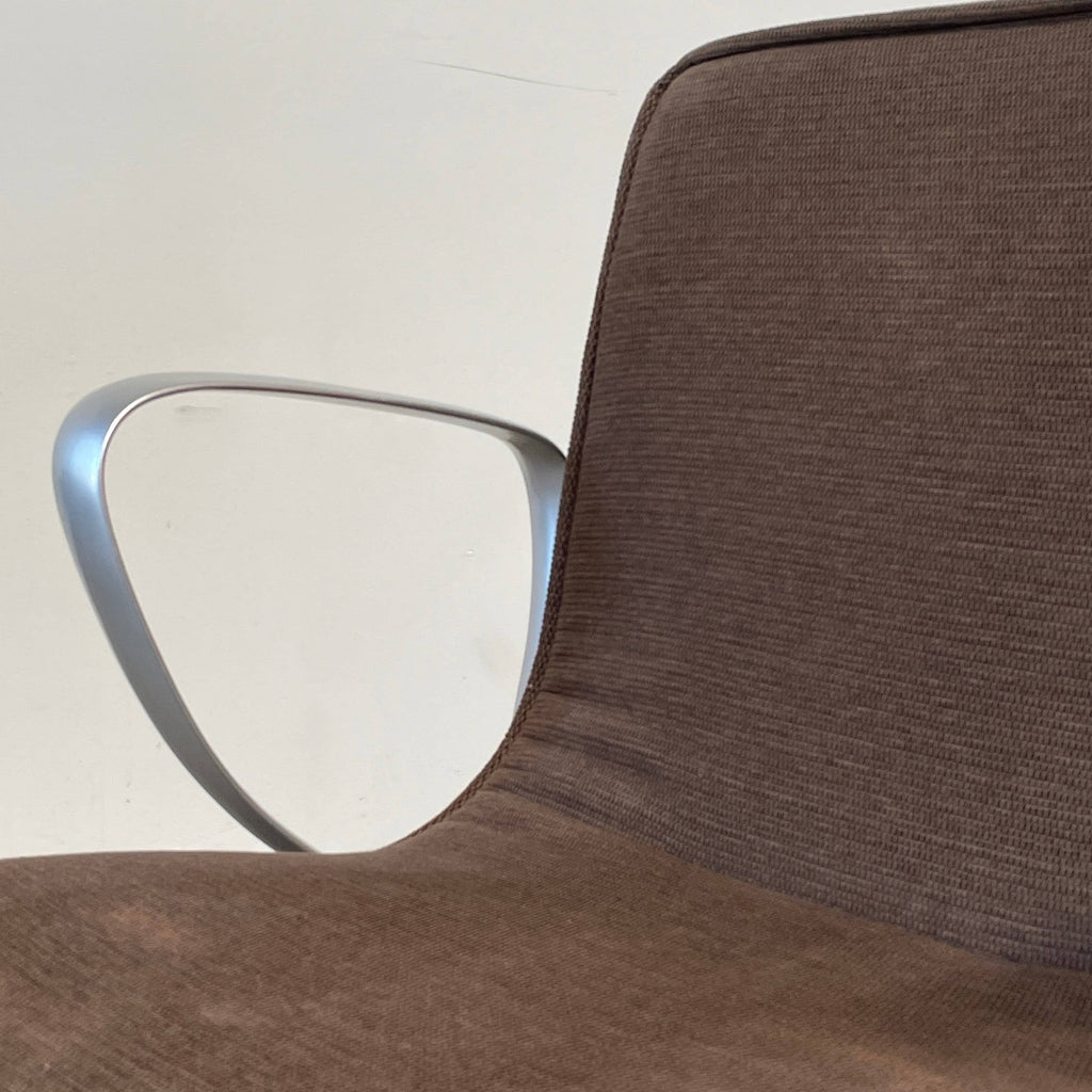 A Ligne Roset Smala Chair with metal legs and a brown upholstered seat.