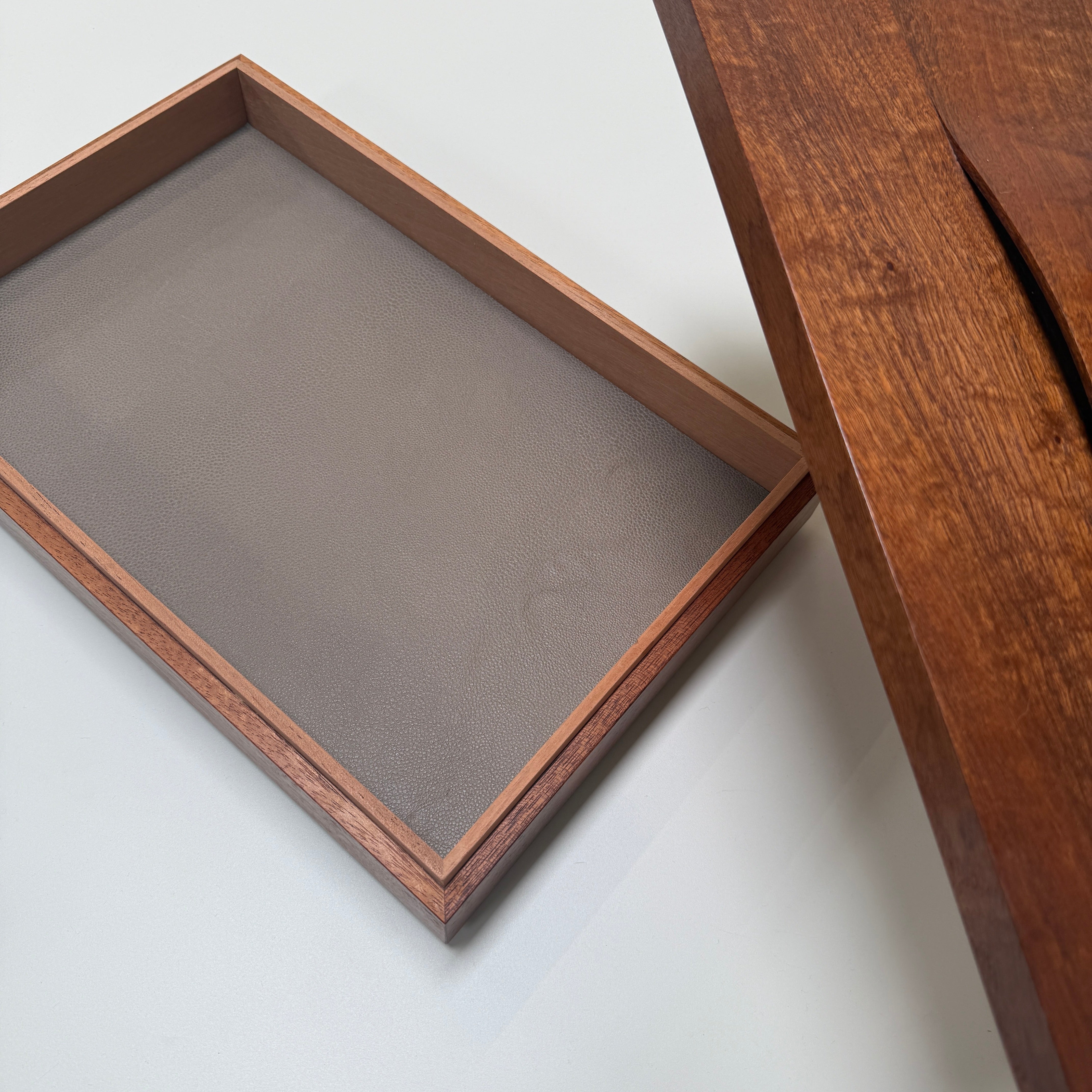 The Mike Fair Jewelry / Cigar Box by Mike Fair Custom Furnishings is a rectangular handcrafted box with a lid featuring a curved cutout and two circular holes, displayed against a plain white background.