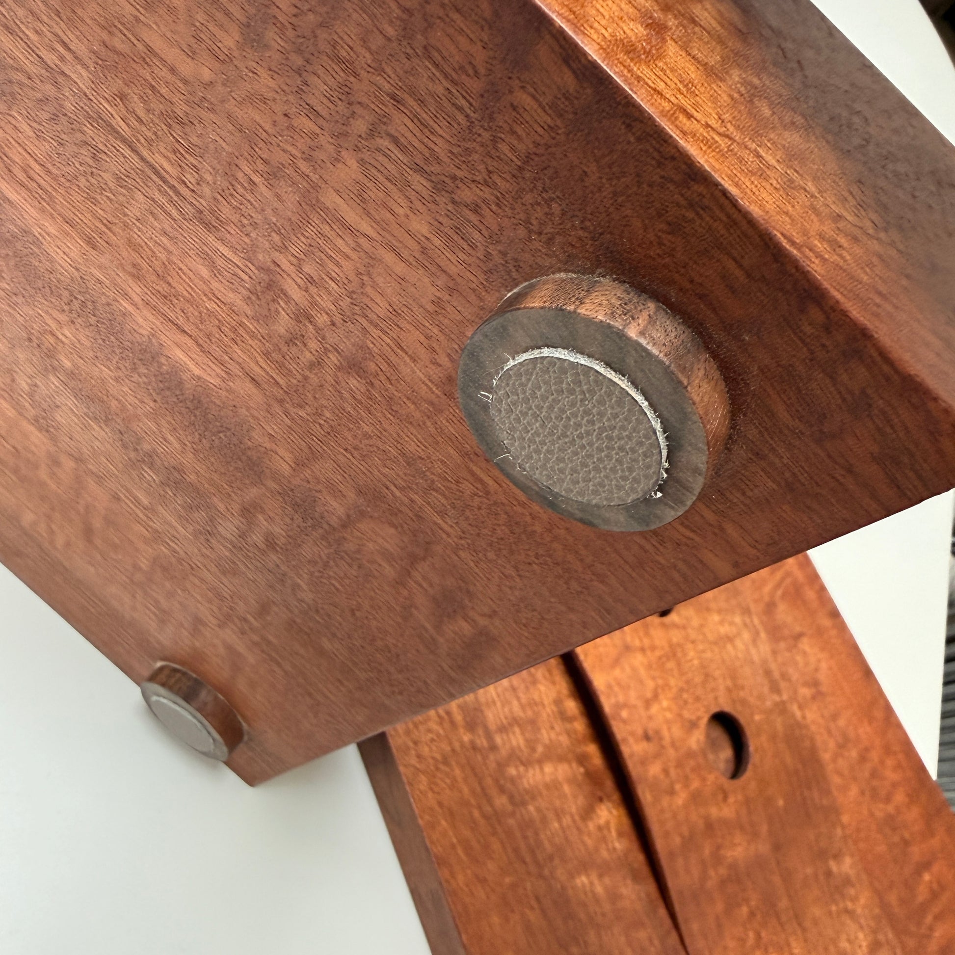 The Mike Fair Jewelry / Cigar Box by Mike Fair Custom Furnishings is a rectangular handcrafted box with a lid featuring a curved cutout and two circular holes, displayed against a plain white background.