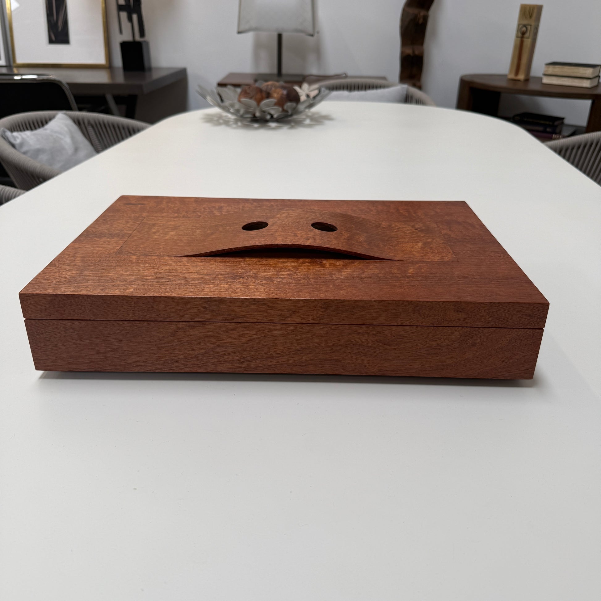 The Mike Fair Jewelry / Cigar Box by Mike Fair Custom Furnishings is a rectangular handcrafted box with a lid featuring a curved cutout and two circular holes, displayed against a plain white background.
