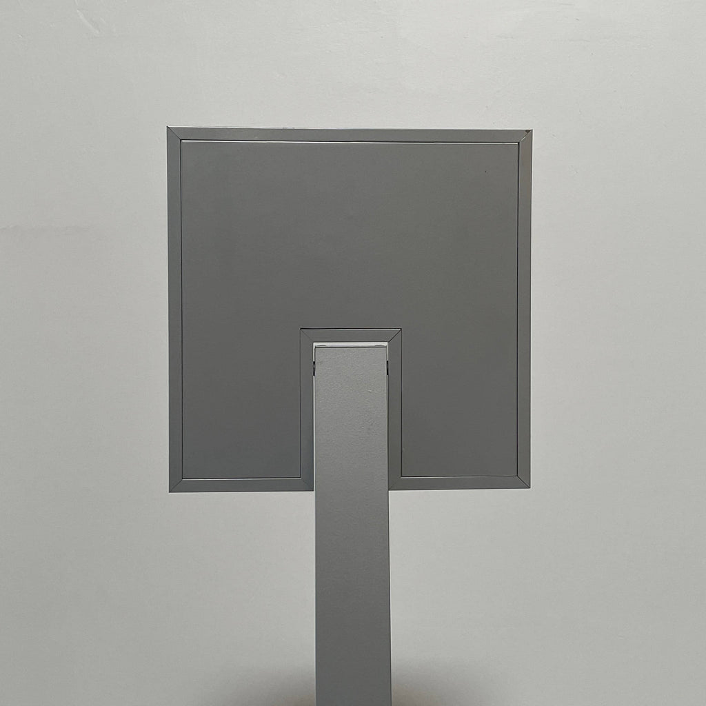 A Ligne Roset Pour Floor Light with a square base.