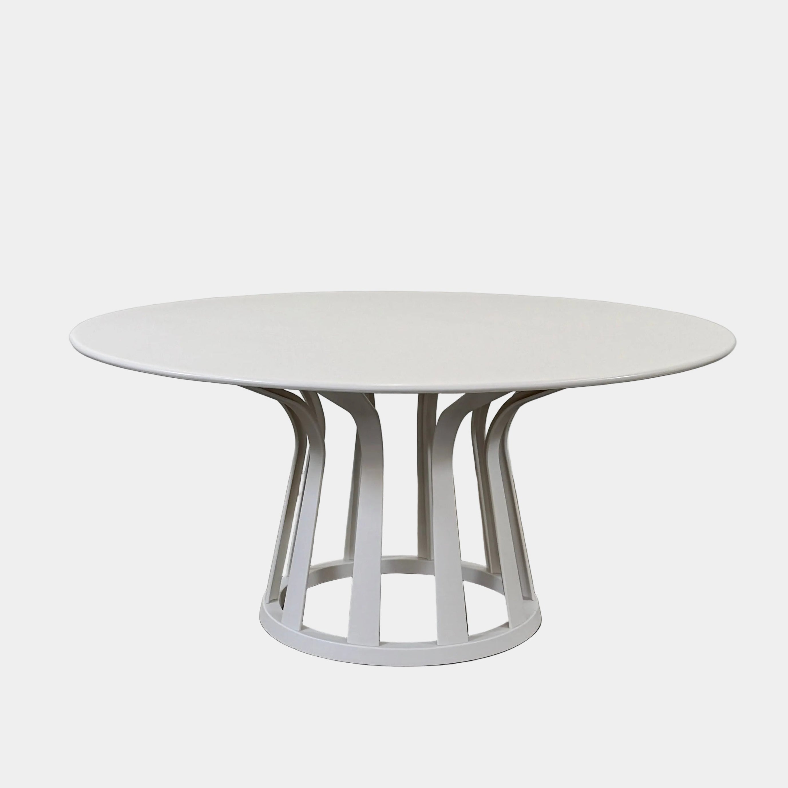 The Cassina Lebeau Outdoor Dining Table by Cassina features a round white porcelain stoneware top and a geometric openwork base, ideal for outdoor dining. Shown on a plain white background.