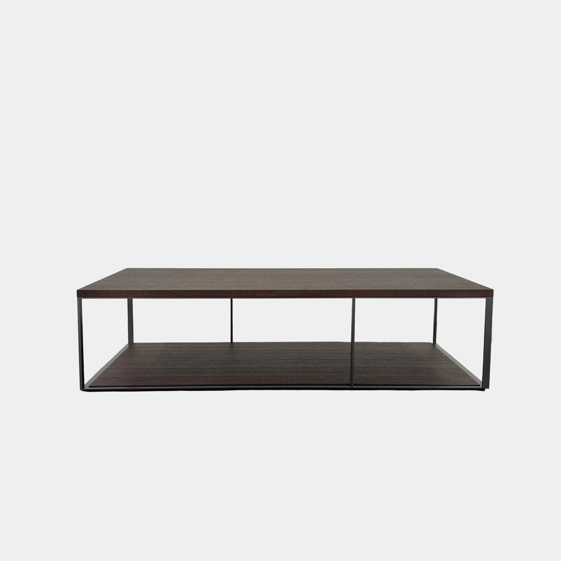 The Maxalto Lithos Coffee Table by Maxalto features a rectangular dark wood top and lower shelf, supported by a minimalist black metal frame, and is displayed against a plain white background.