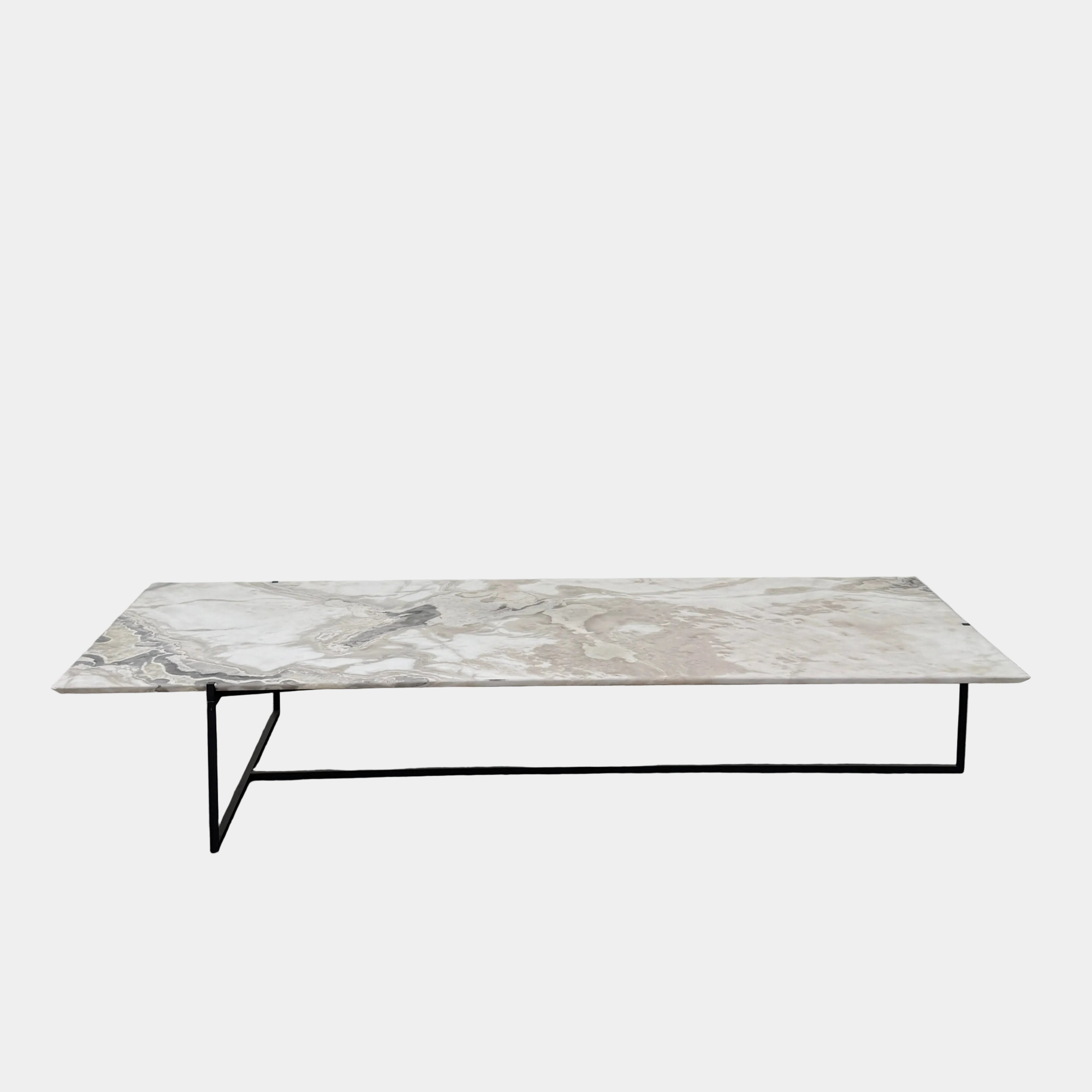 The Baxter Icaro Rectangular Coffee Table by Baxter features a Polar White Marble top with off-white, gray, and beige veining on a slim black metal frame, shown against a white background for a modern look.