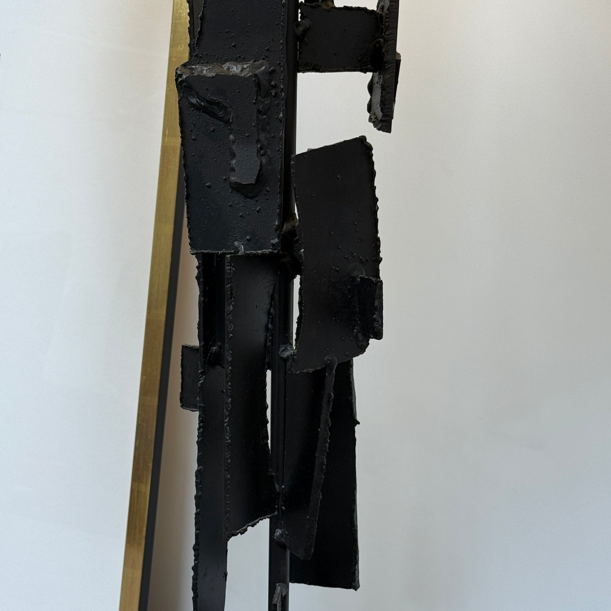 A pair of Vintage Richard Barr Iron Brutalist table lamps for Laurel Lamp Co., featuring abstract black metal bases and cylindrical white shades, set against a plain white background.