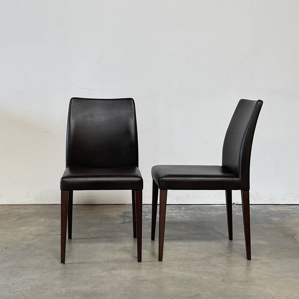 Four brown leather dining chairs against a white background from the Poltrona Frau Liz Dining Chair Set.