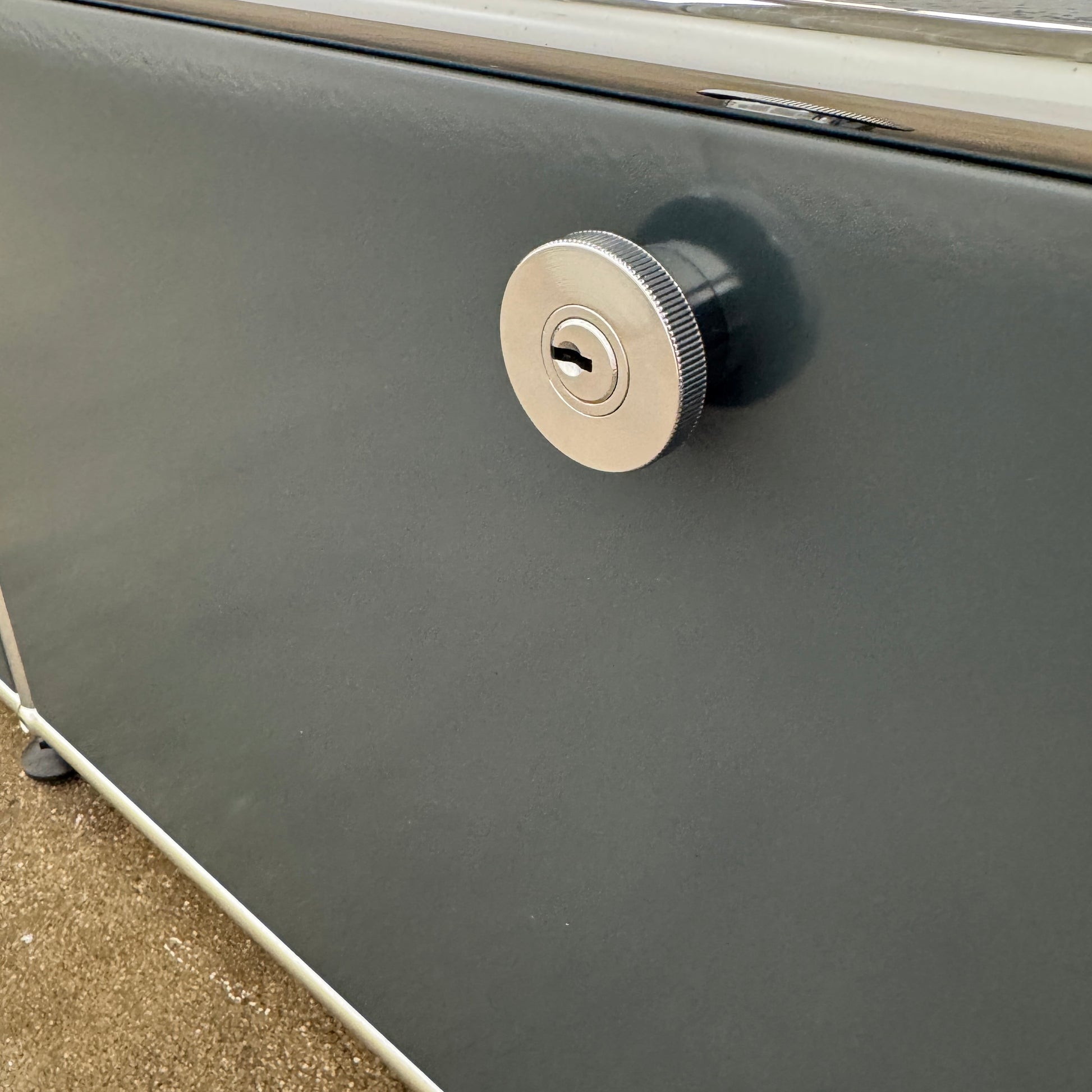The USM Haller Low Console - Three Flap Door Unit features three black flap doors with round knobs and a silver frame, shown against a plain white background.