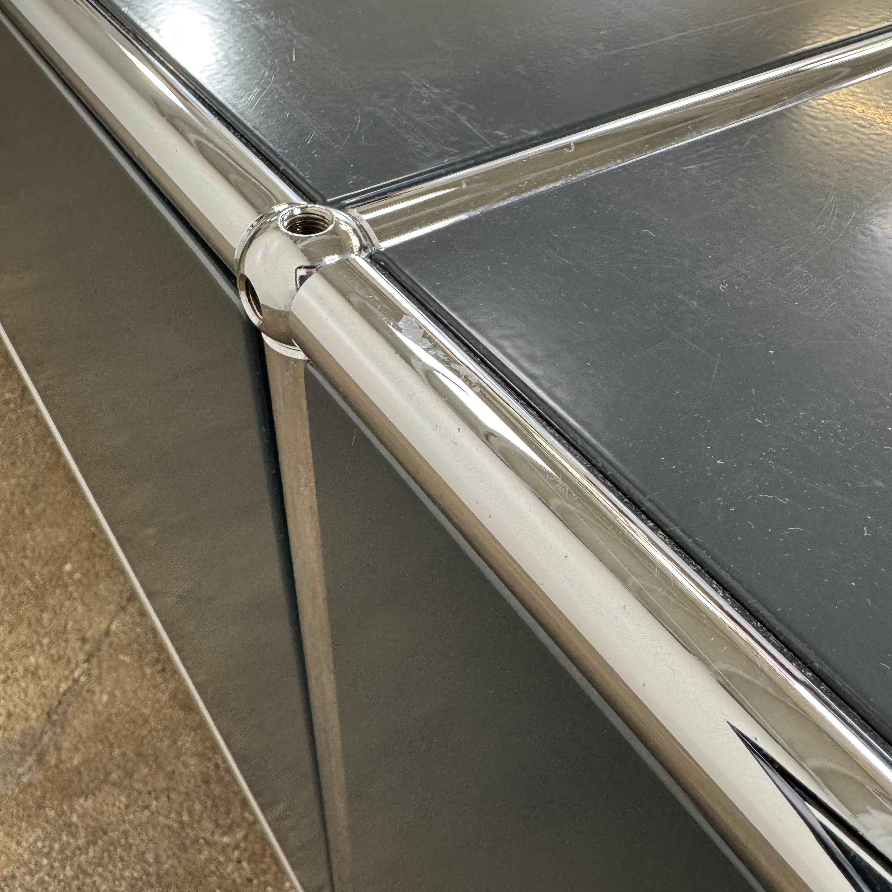 The USM Haller Low Console - Three Flap Door Unit features three black flap doors with round knobs and a silver frame, shown against a plain white background.