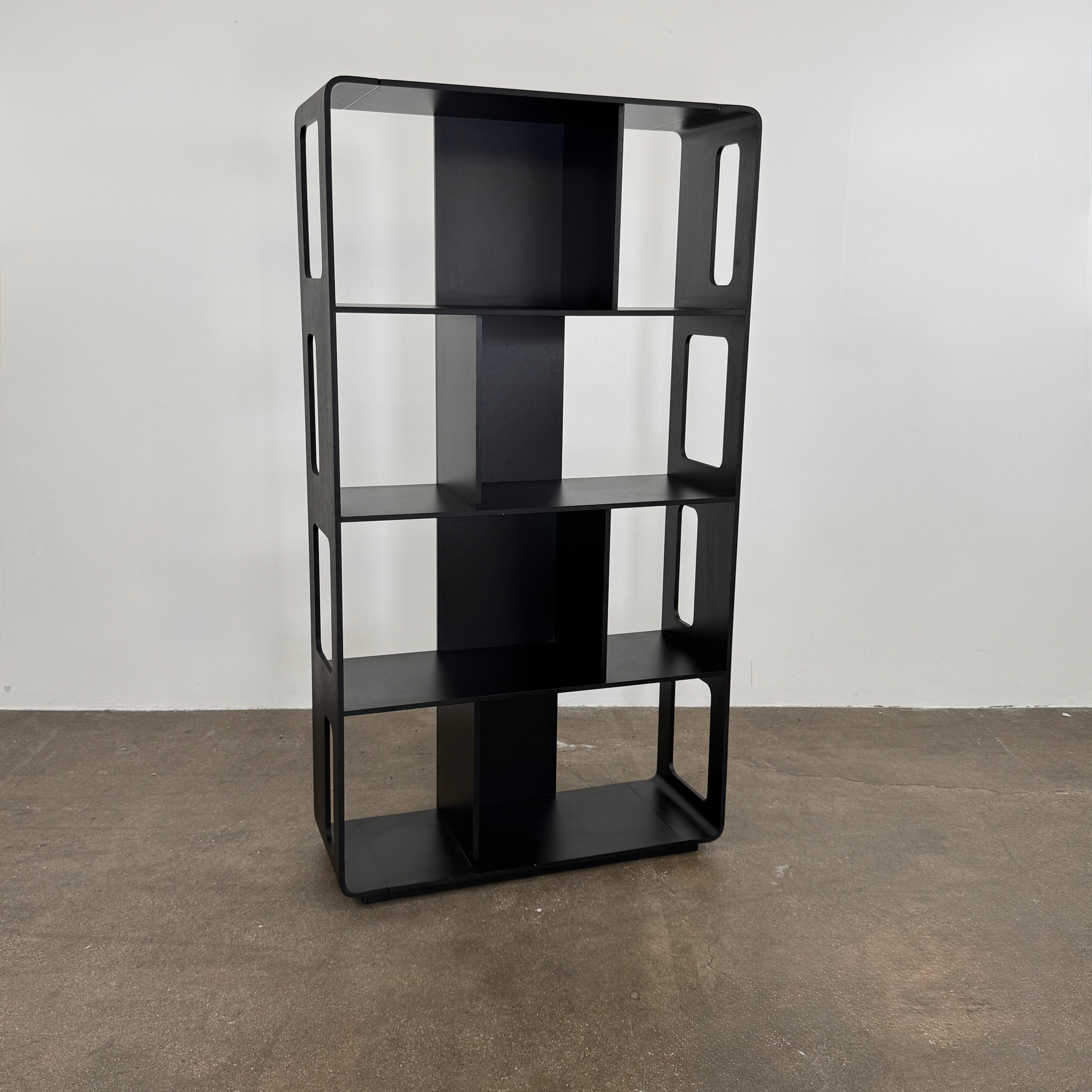 The B&B Italia Arne Bookcase Black Oak by B&B Italia is a modern open-frame bookshelf with five shelves and rectangular side cutouts, inspired by the Arne design, shown against a plain white background.