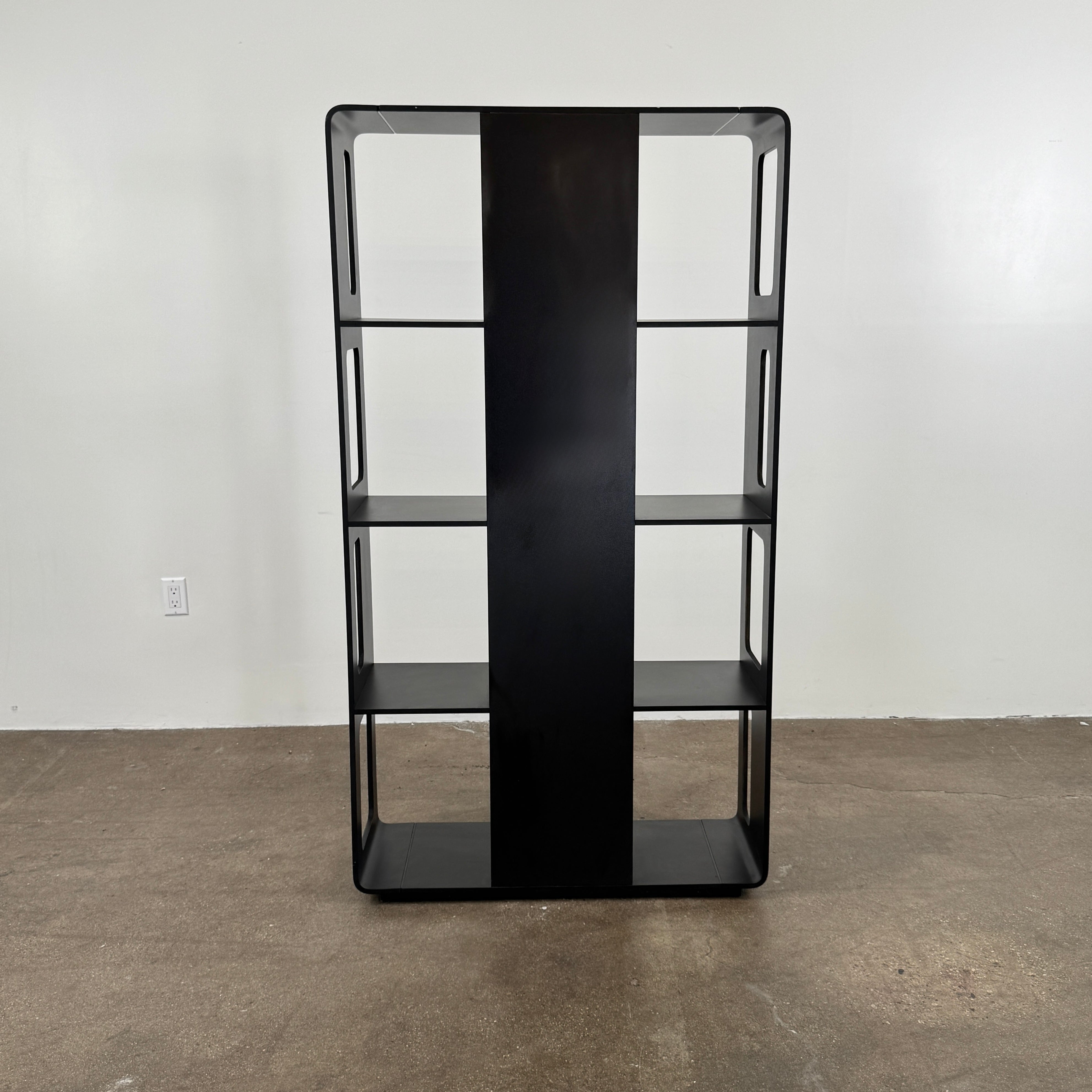 The B&B Italia Arne Bookcase Black Oak by B&B Italia is a modern open-frame bookshelf with five shelves and rectangular side cutouts, inspired by the Arne design, shown against a plain white background.