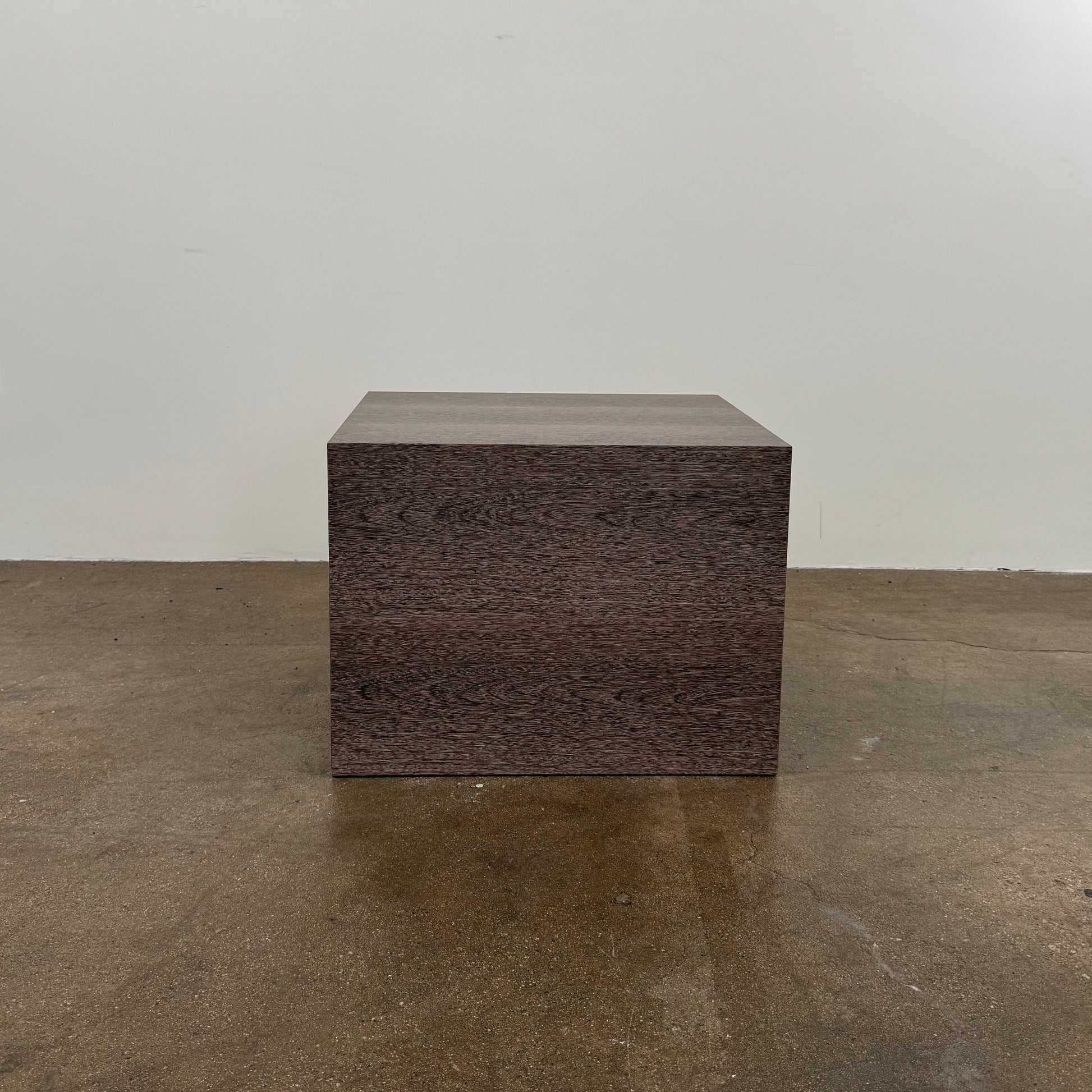 The Maxalto Arke Side Table by Maxalto is a square Sucupira wood accent table with a minimalist design, thick legs, and an open space beneath, shown against a plain white background.