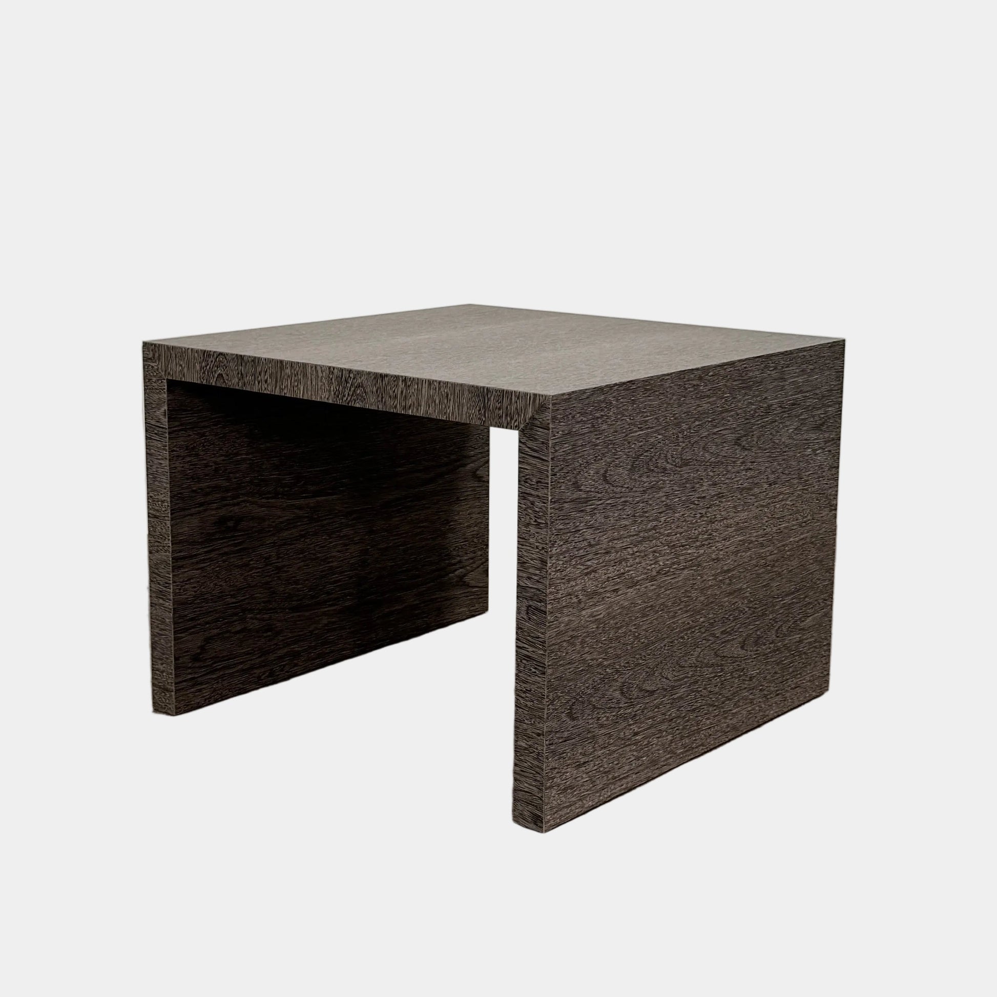 The Maxalto Arke Side Table by Maxalto is a square Sucupira wood accent table with a minimalist design, thick legs, and an open space beneath, shown against a plain white background.