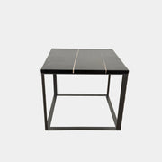 The Maxalto Lithos Side Table Sahara Noir Marble Top by Maxalto features a square black frame designed by Antonio Citterio and a marble top with subtle light veining.