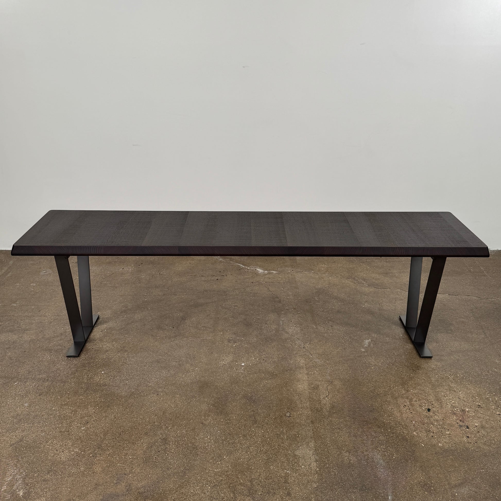 A modern luxury, rectangular wooden B&B Italia Luis Bench with angled metal legs by B&B Italia, shown on a plain white background and inspired by the refined aesthetic of Antonio Citterio.